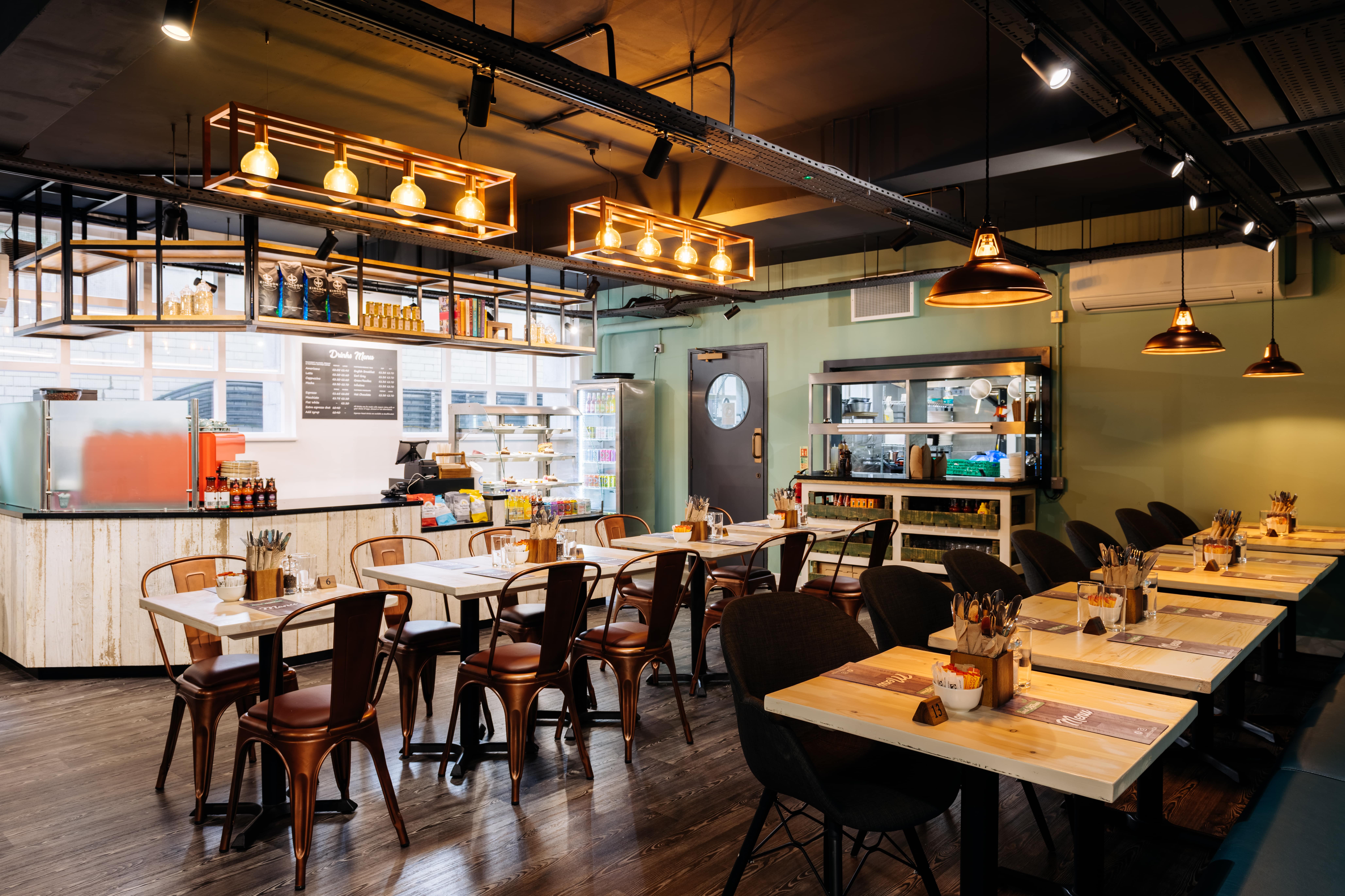 Modern Leslie Forster Suite restaurant with wooden tables, ideal for events and meetings.