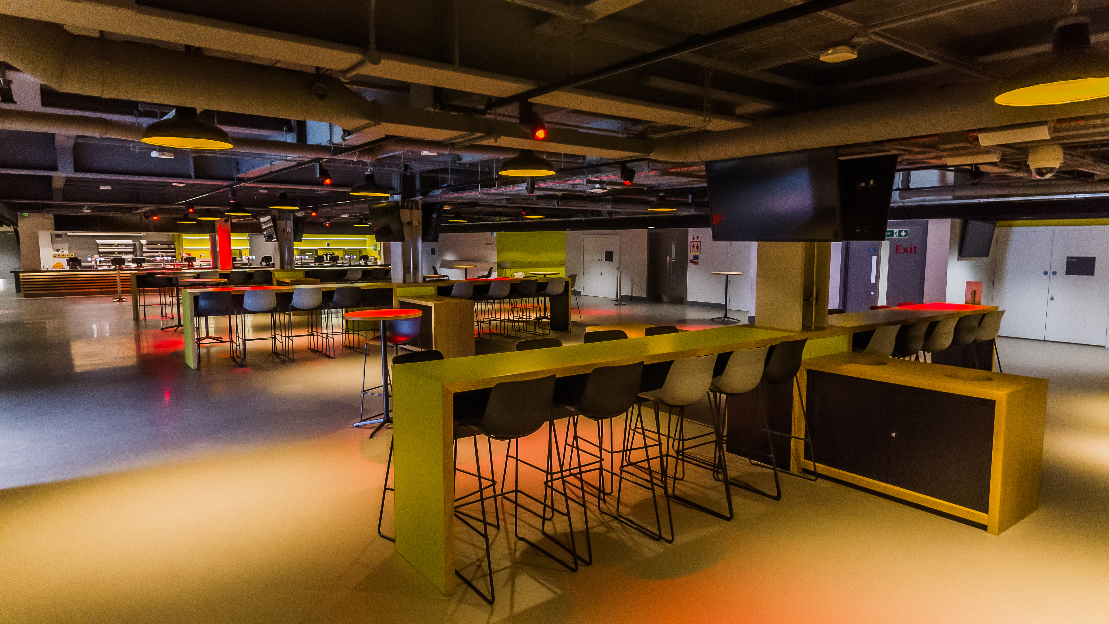 Modern event space at Brentford FC with high-top tables, ideal for networking and receptions.
