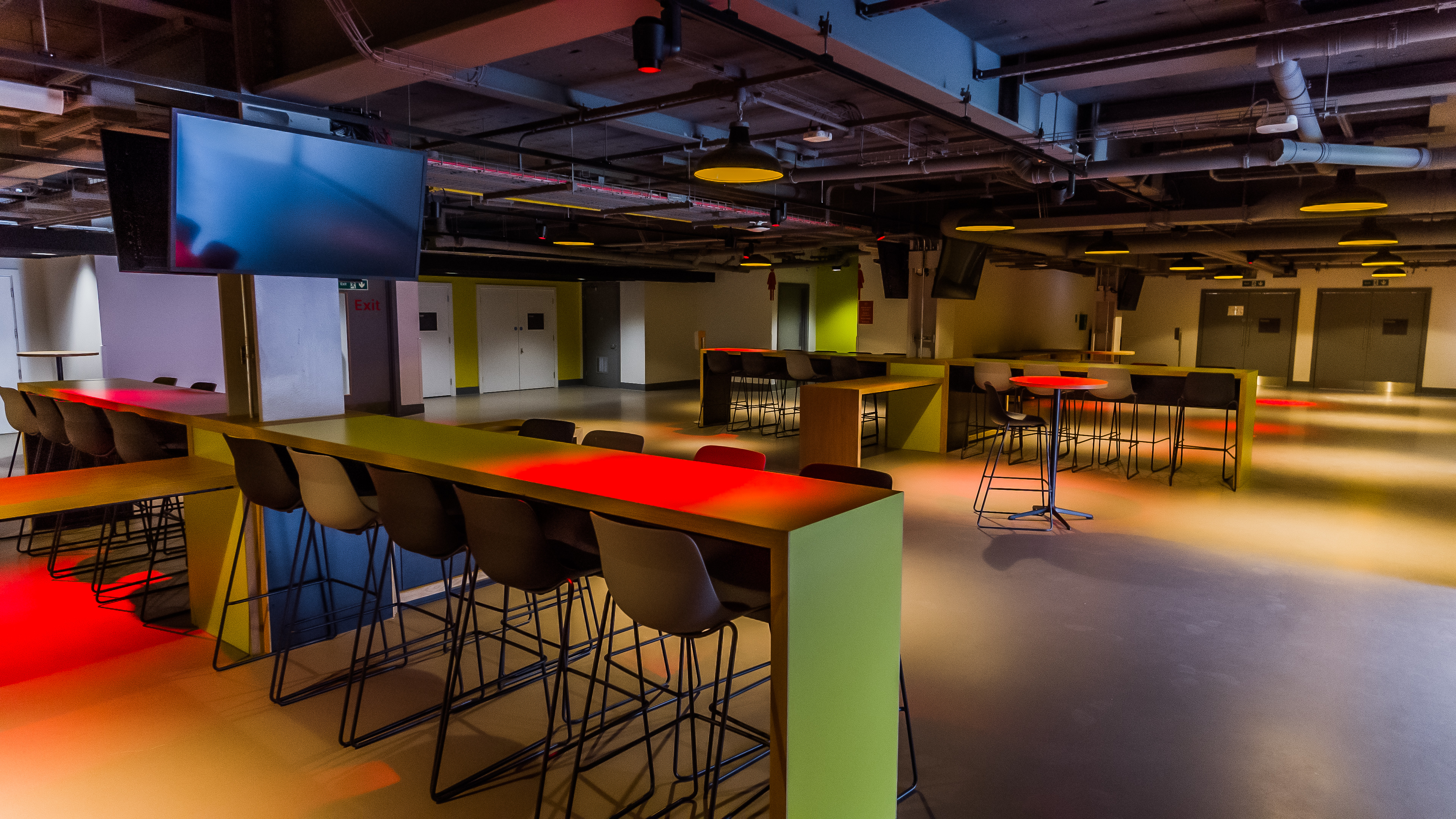 Modern event space at Brentford FC with high-top tables, ideal for networking events.