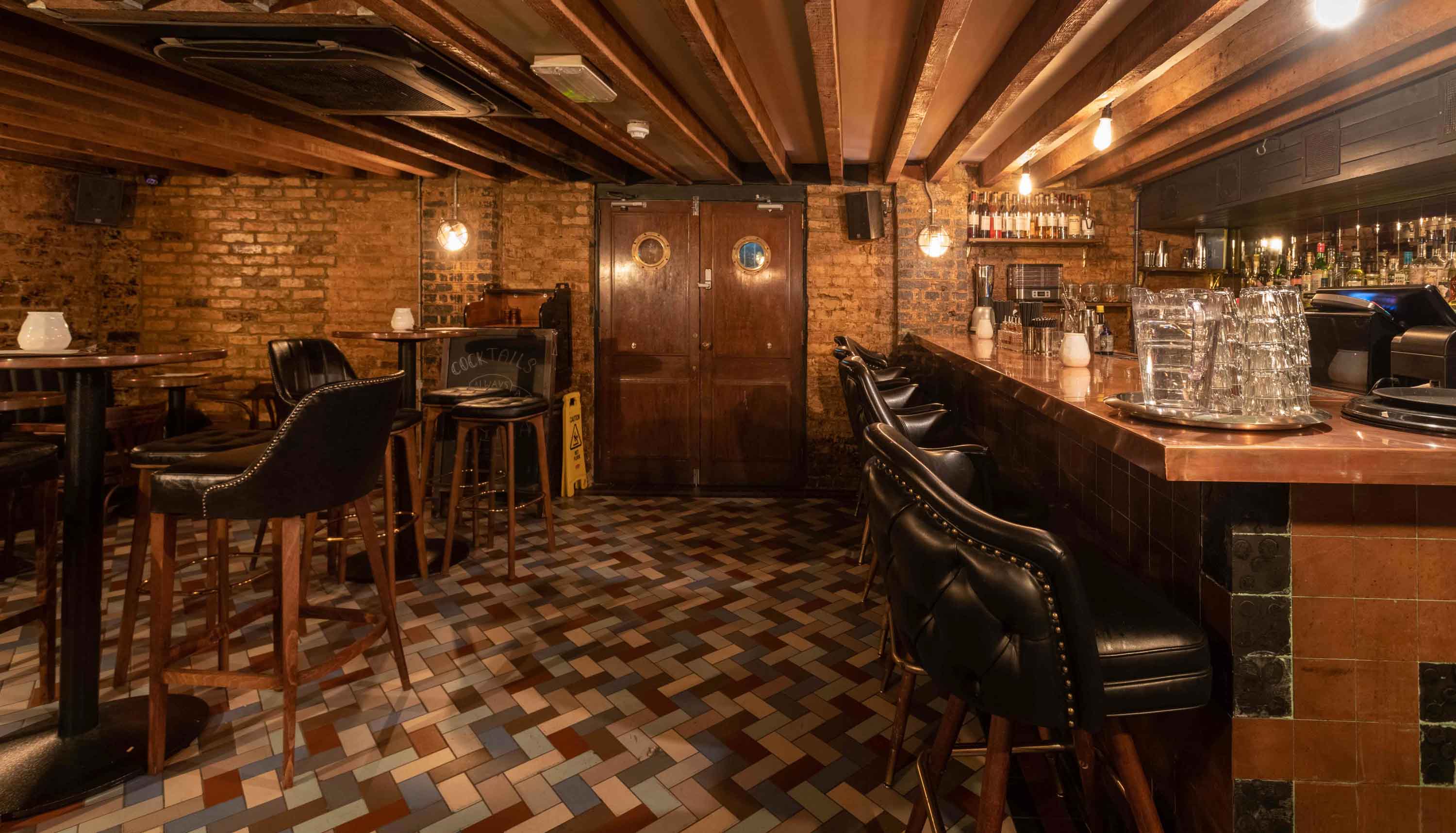 Stylish venue with rustic brick walls, ideal for networking events and gatherings.