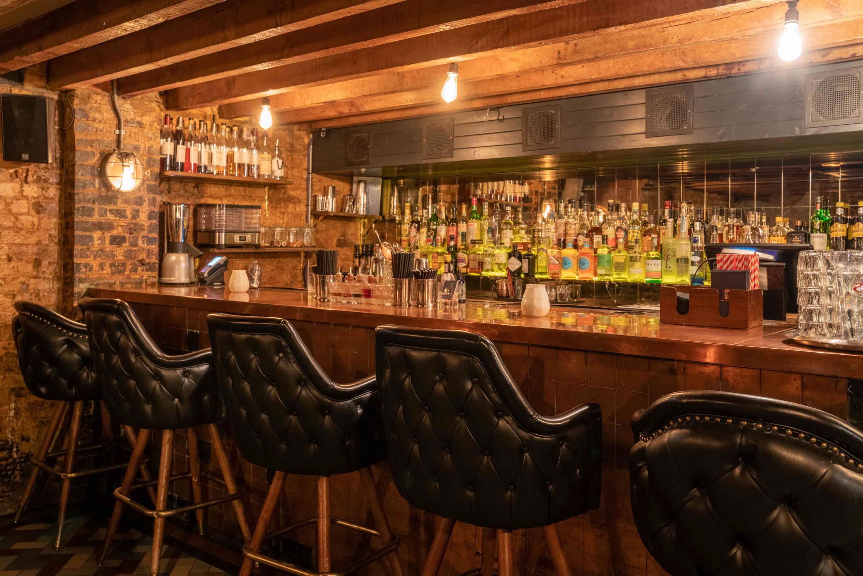 Stylish bar with leather stools, ideal for cocktail receptions and networking events.