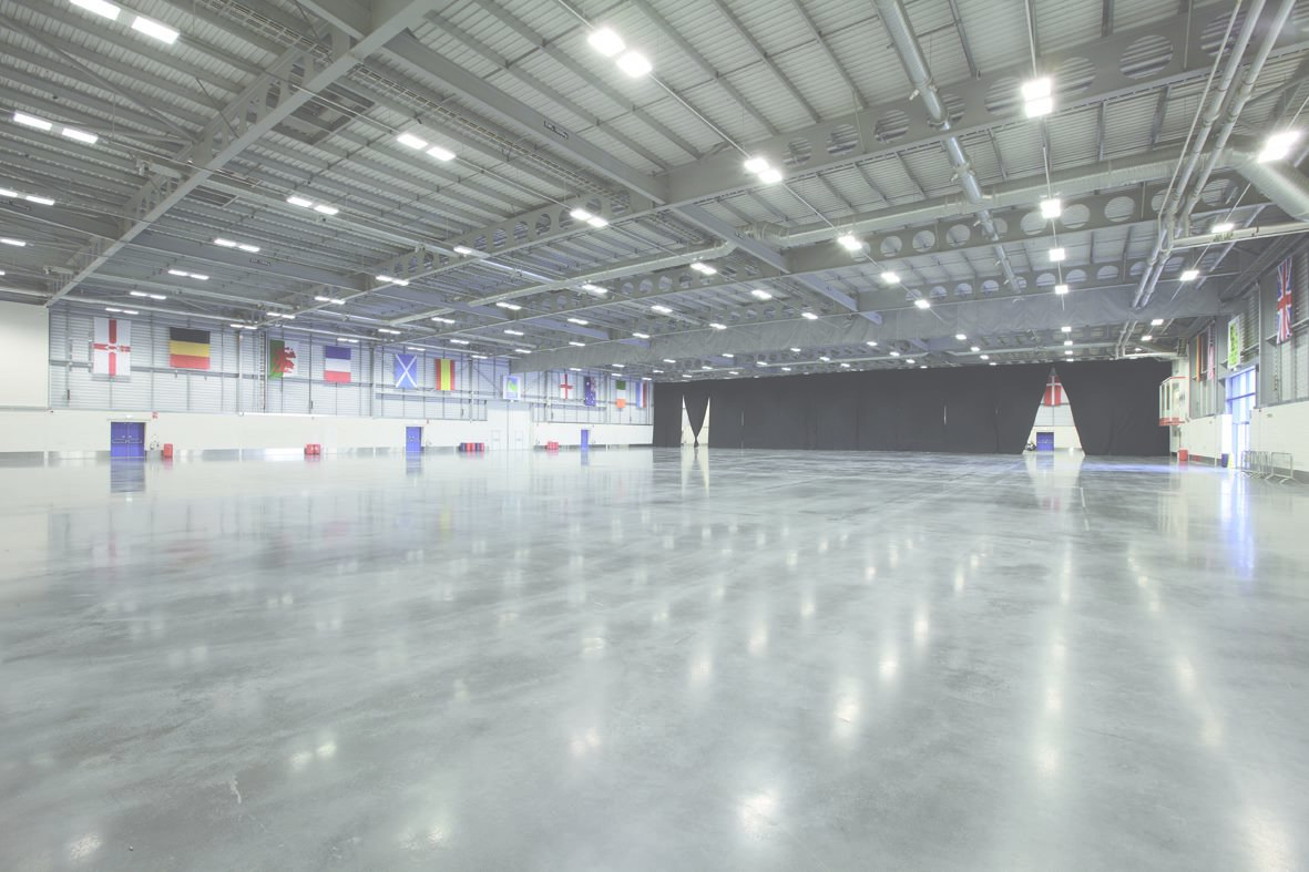 Spacious East of England Arena event hall with polished concrete floor for trade shows.