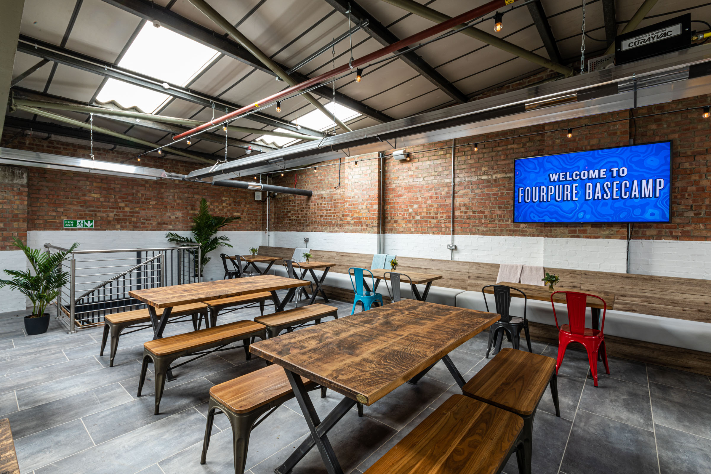 Versatile event space at Fourpure Taproom with industrial-chic decor for workshops.