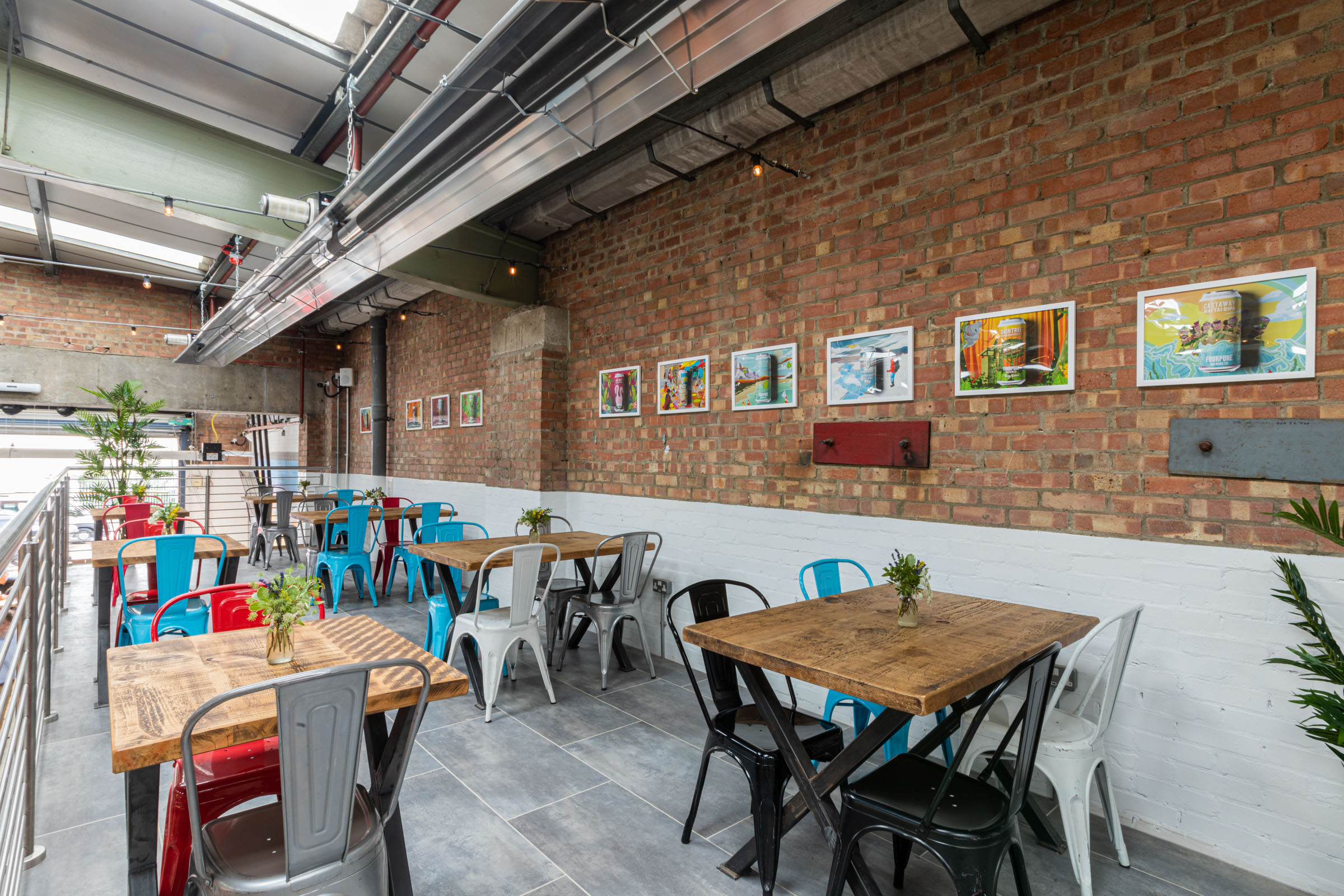 Stylish industrial venue with colorful chairs for casual meetings and events.