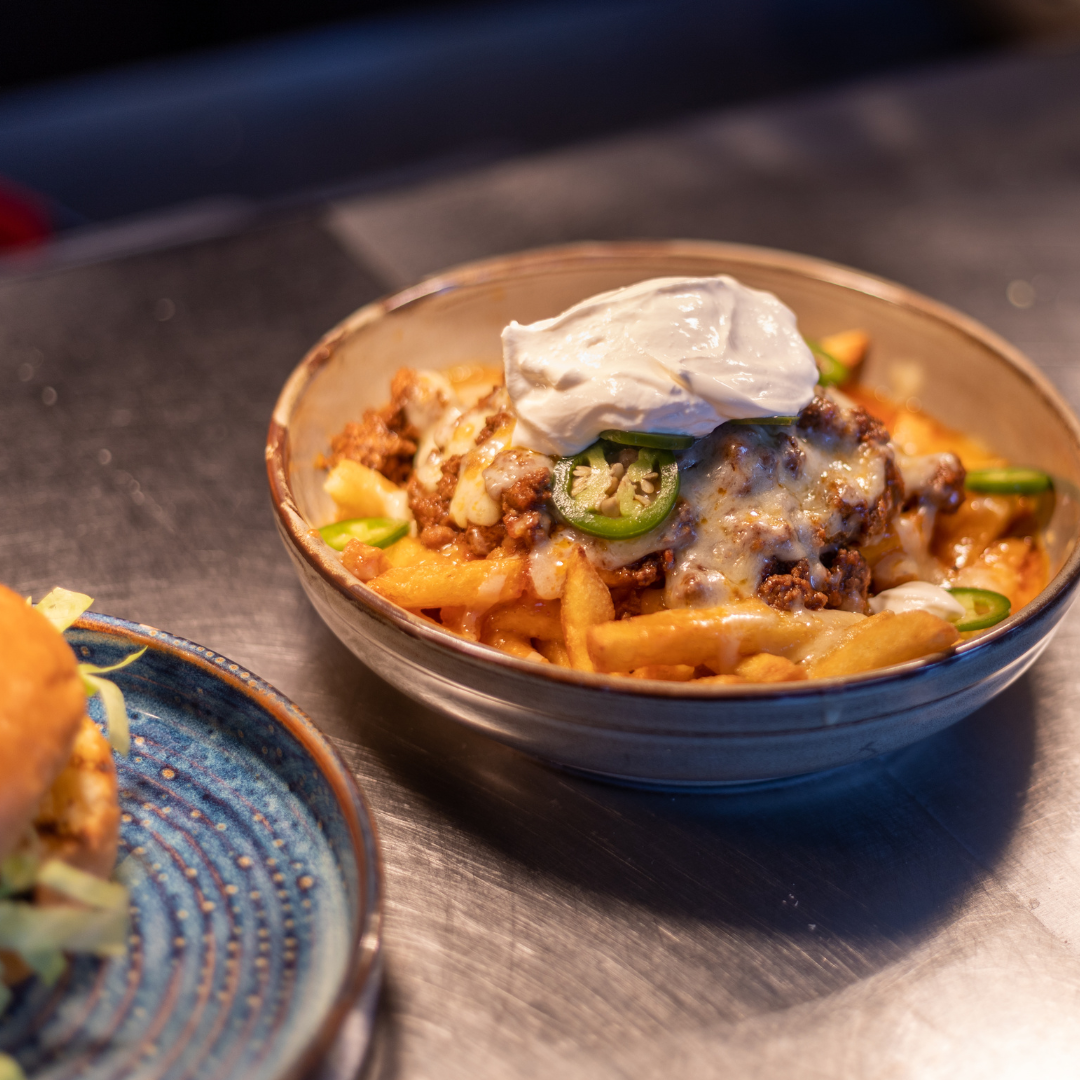 Loaded fries with chili and cheese at Babel Beerhouse for networking events.