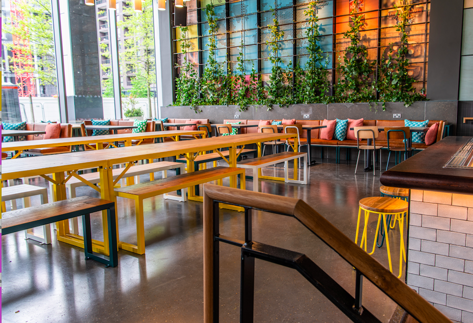 Vibrant event space at Babel Beerhouse with communal seating for networking events.