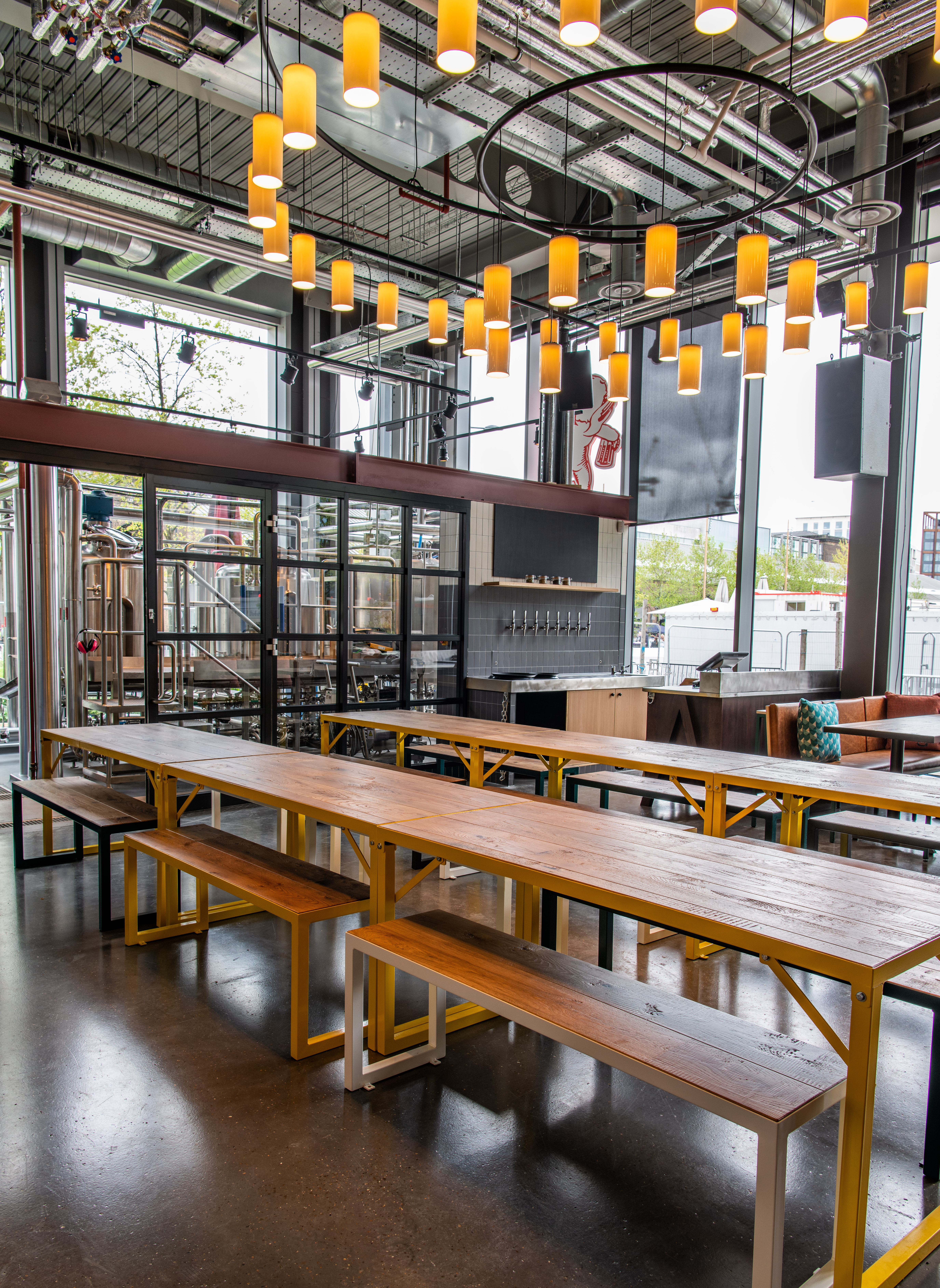 Modern industrial venue with communal tables for casual meetings and networking events.