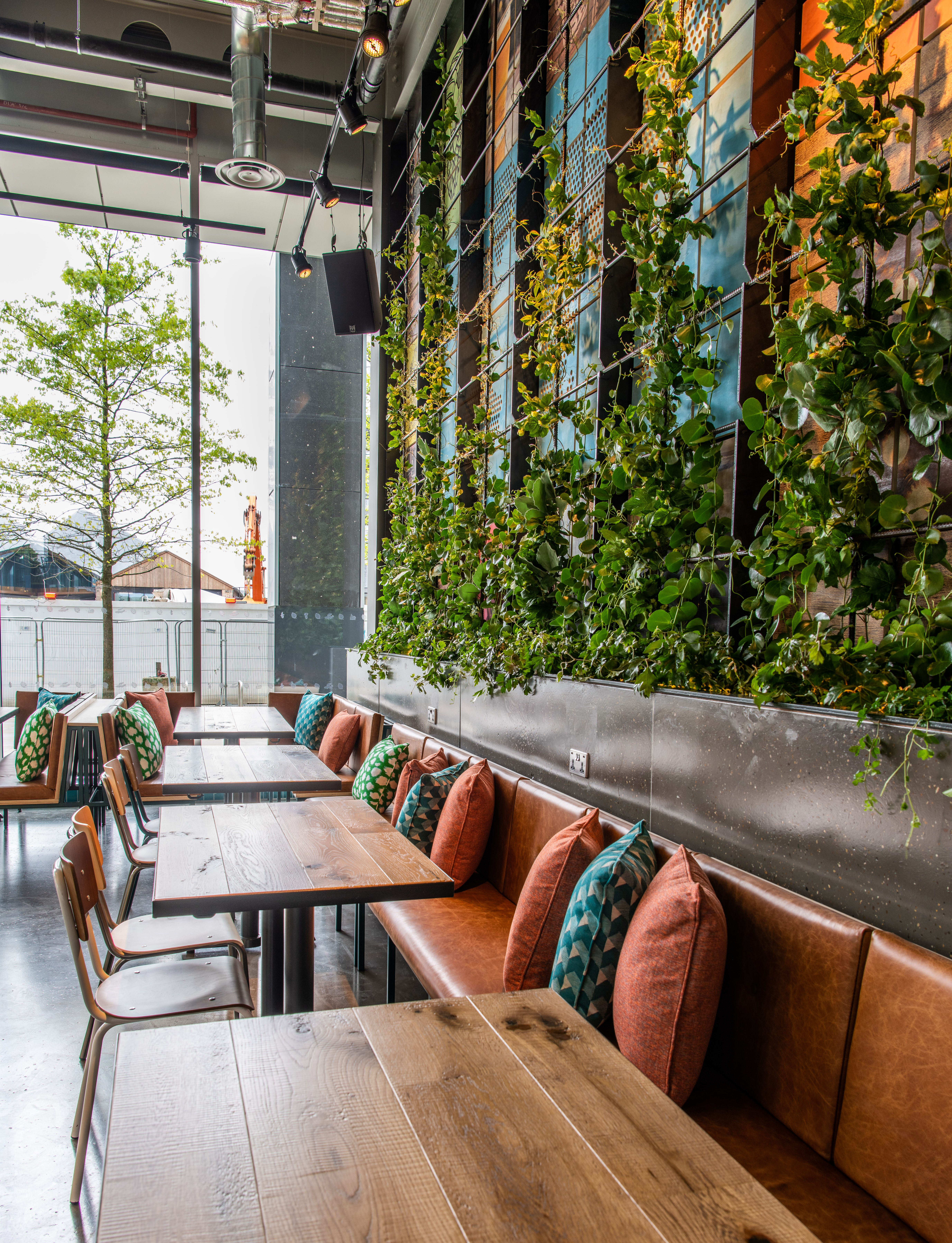 Modern Babel Beerhouse venue with green plant wall, perfect for events and meetings.
