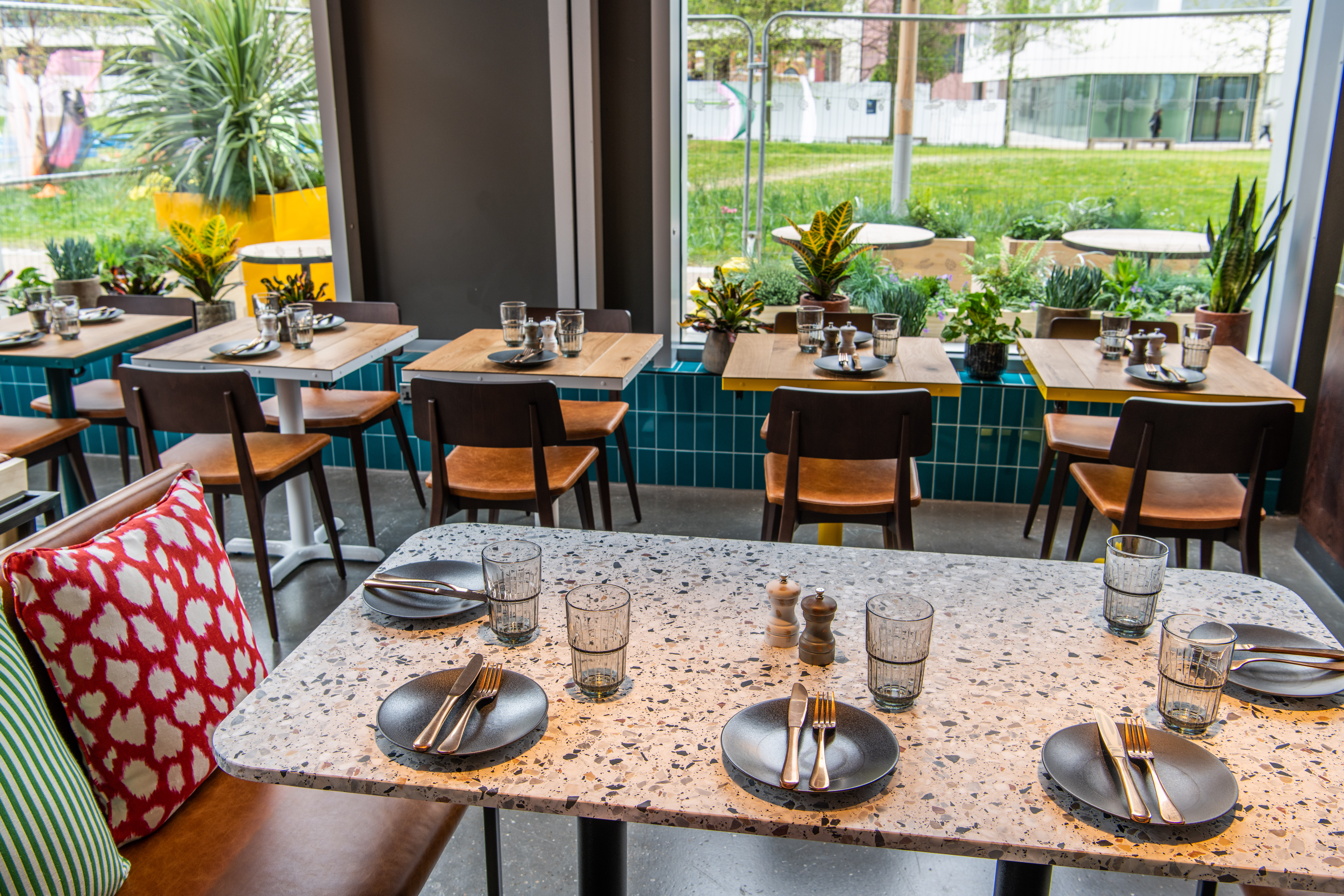 Intimate dining space at Babel Beerhouse with modern tables for events and meetings.