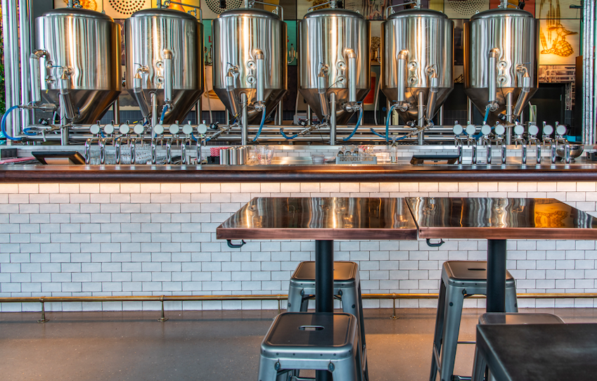 Modern brewery with stainless steel tanks, ideal for corporate events and gatherings.