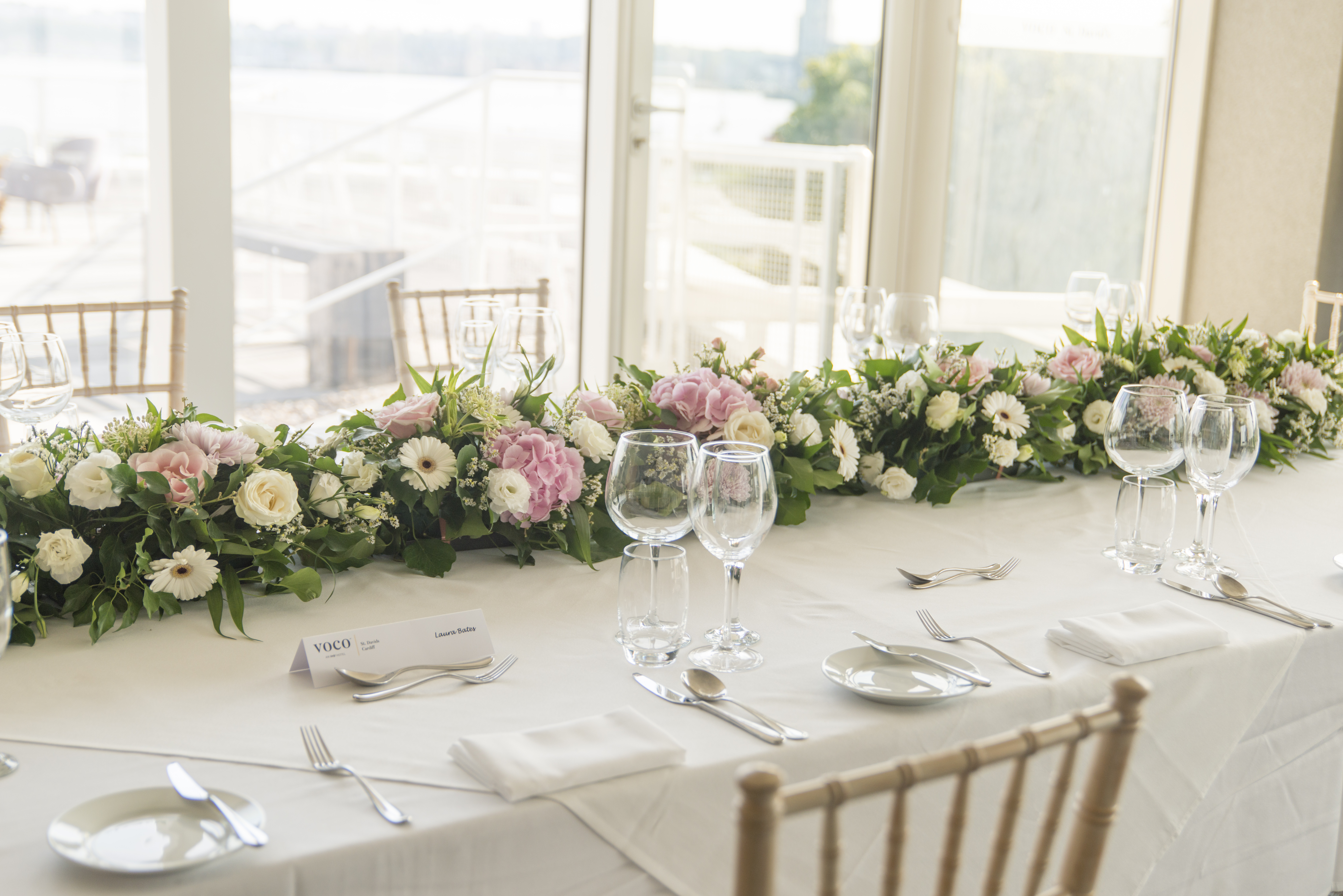 Elegant table setting with floral centerpiece at Voco St David's Cardiff for weddings.