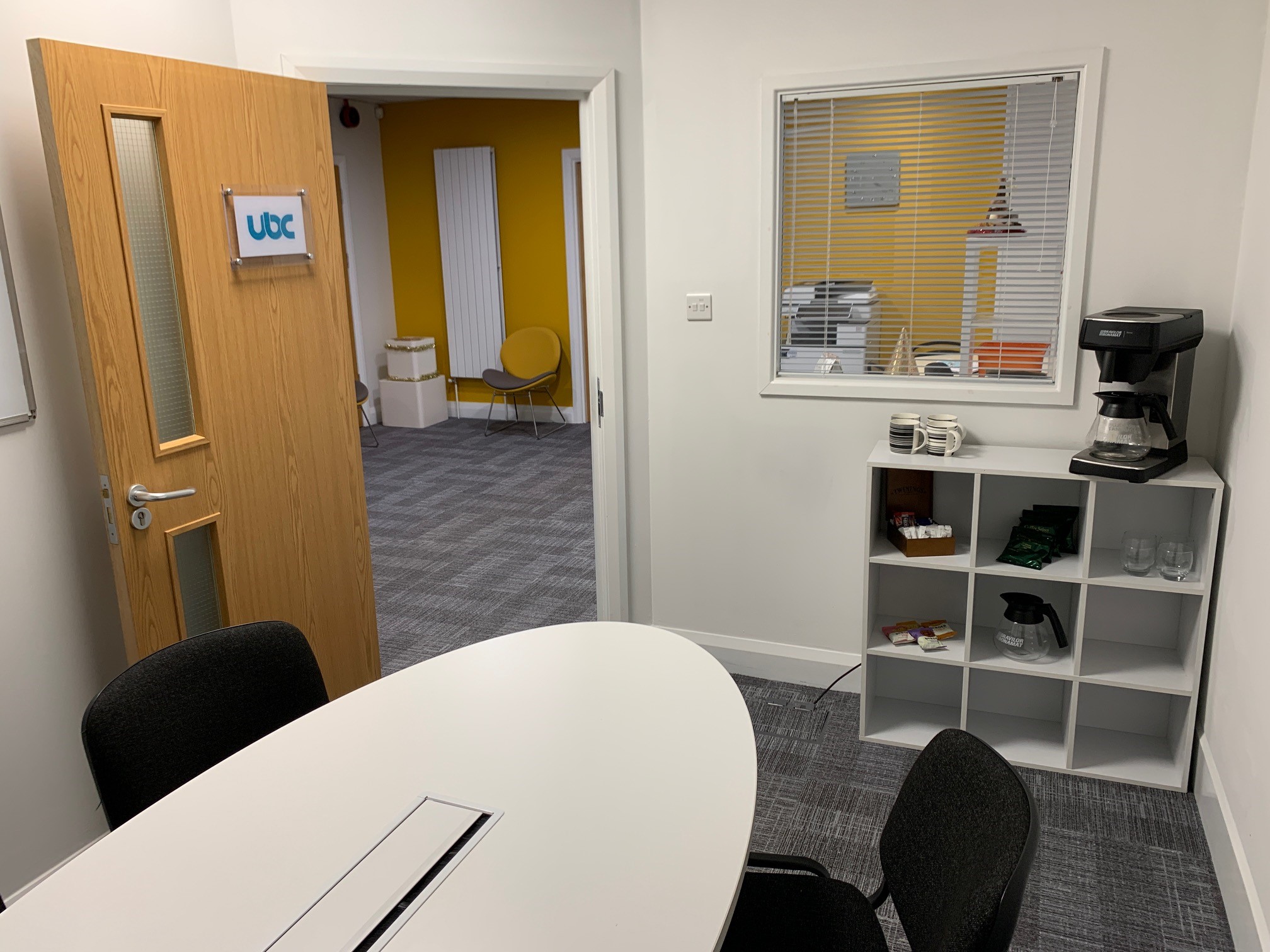 Modern meeting room at UBC Thursby House with round table for brainstorming sessions.