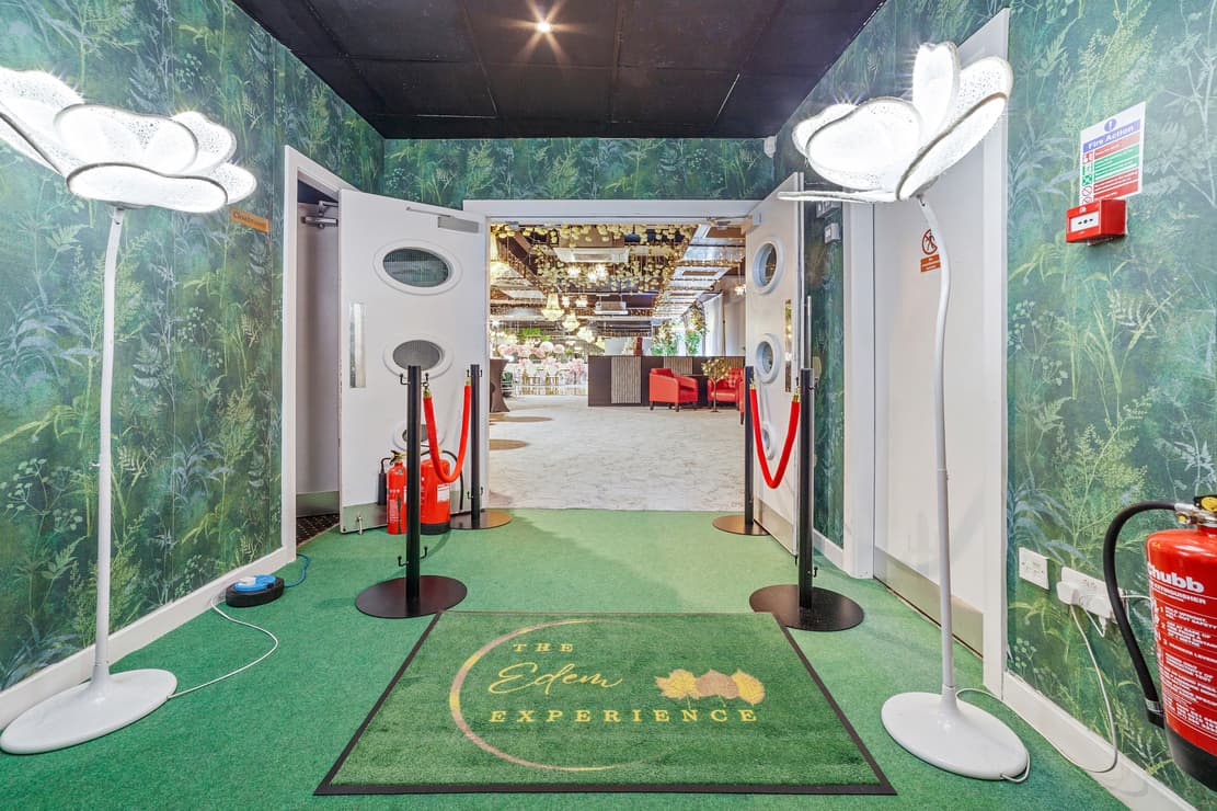 Branded Main Hall entryway with stanchions for corporate event arrival and guest check-in.