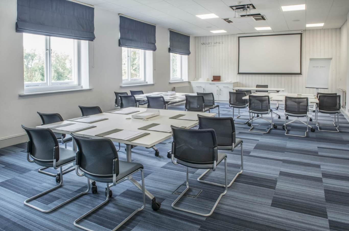 Modern meeting room with flexible seating at De Vere Beaumont Estate for workshops.