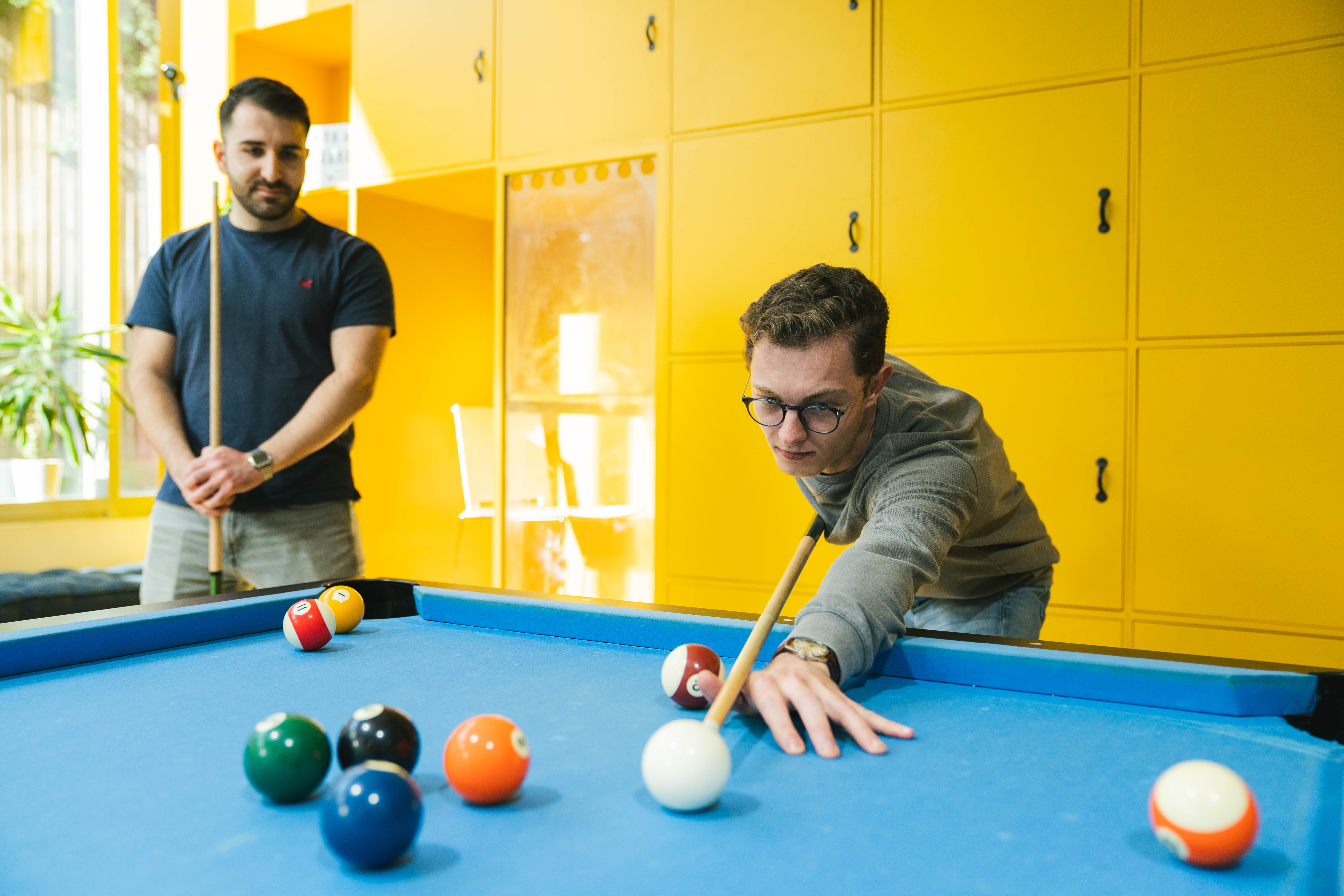 Event space with pool table, ideal for team-building and networking activities.