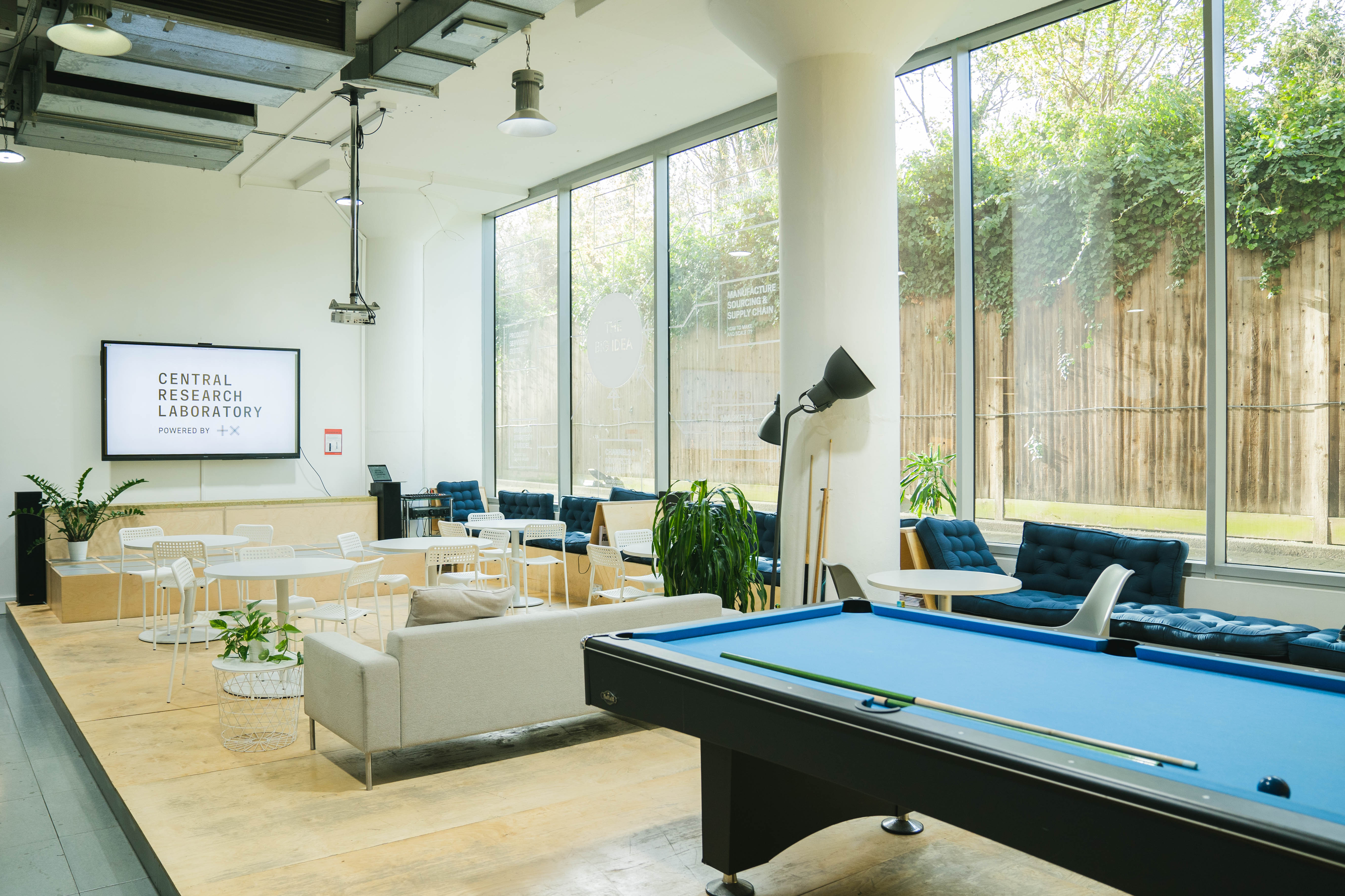 Modern event space with natural light, ideal for meetings and team bonding.