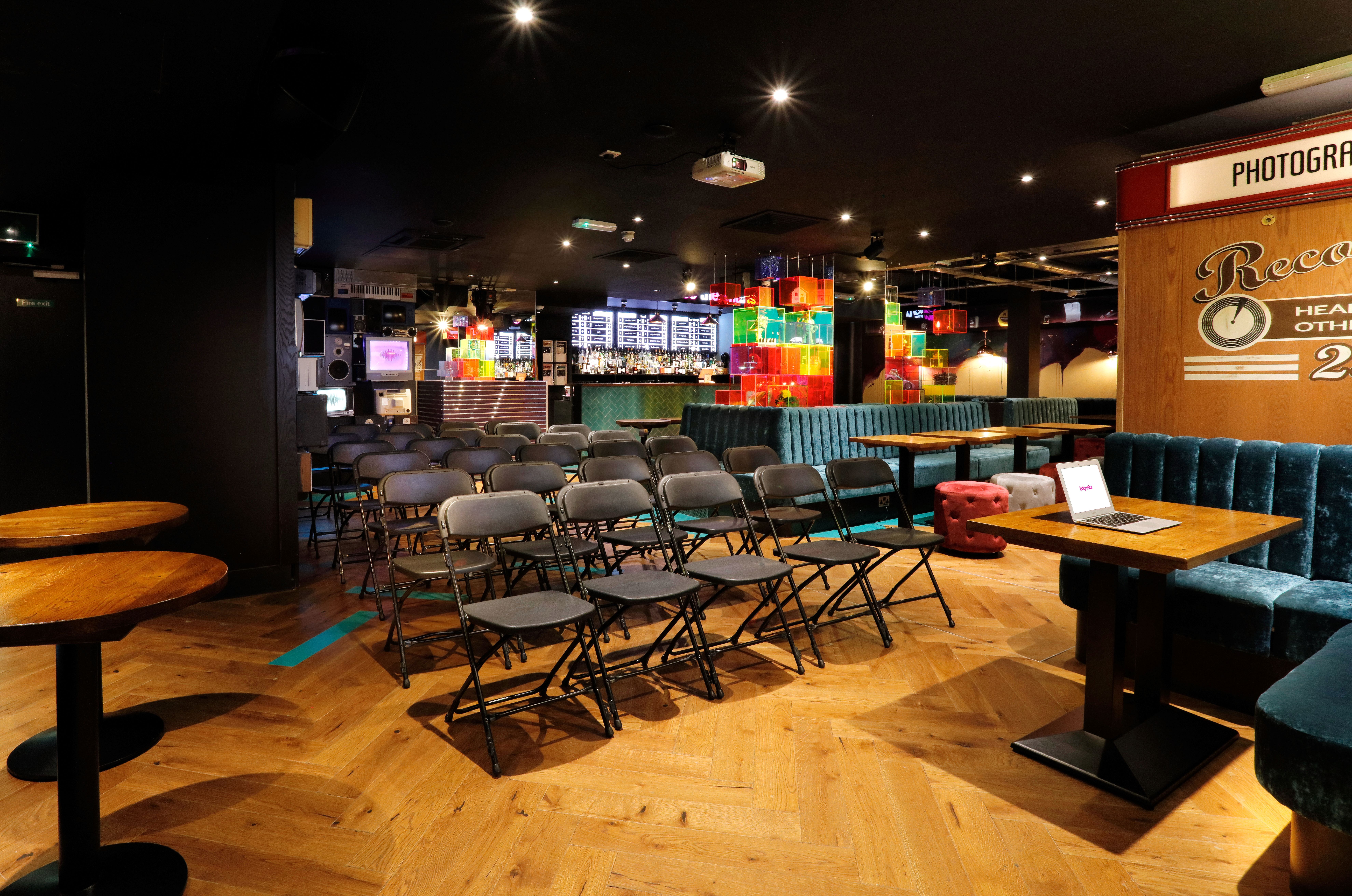 Versatile event space at Lucky Voice Holborn with vibrant lighting for meetings and presentations.