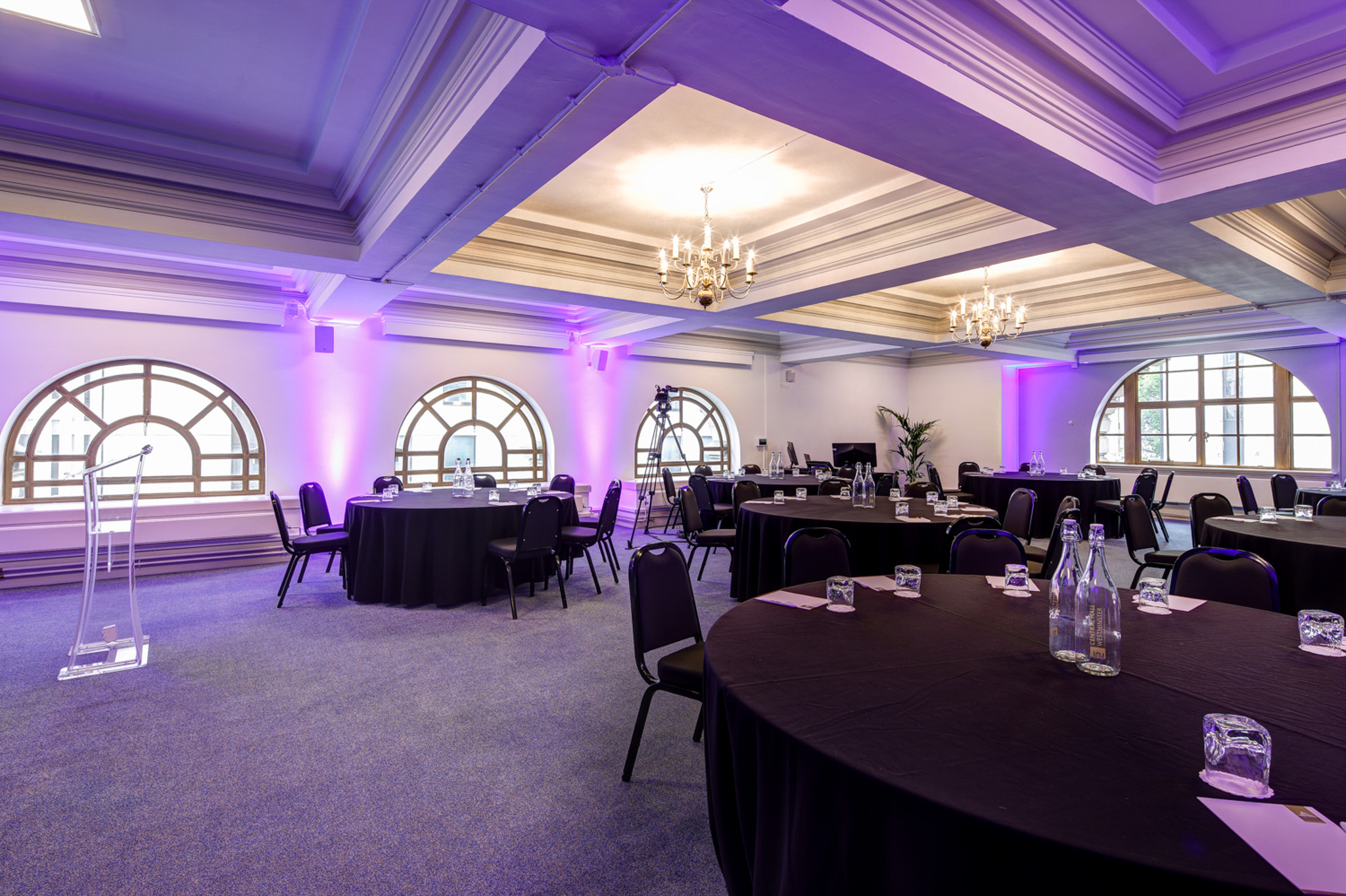 Donald English speaking in Central Hall Westminster, elegant event space with purple lighting.