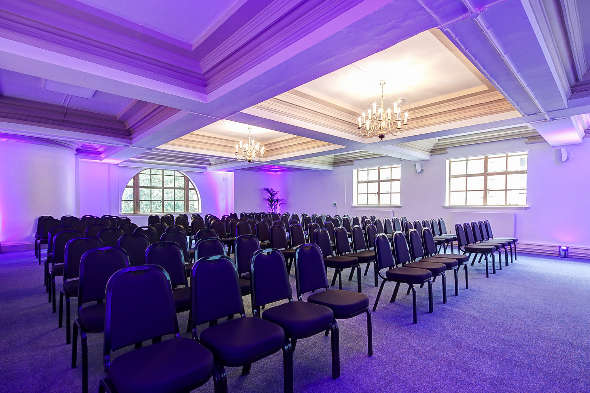 William Sangster in Central Hall Westminster, elegant conference setup with purple lighting.
