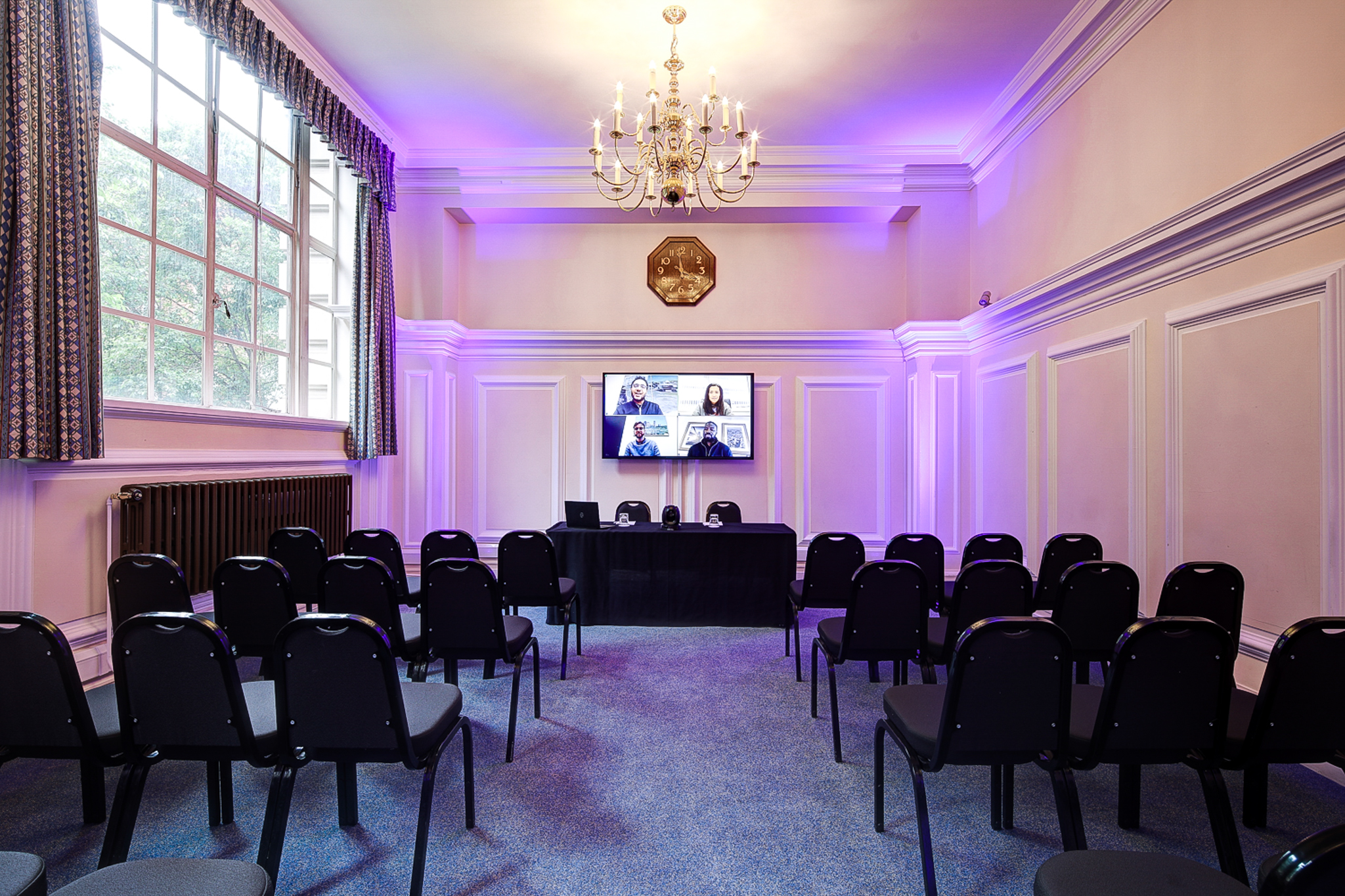Dinsdale Young in a hybrid event meeting room with large screen and flexible seating.
