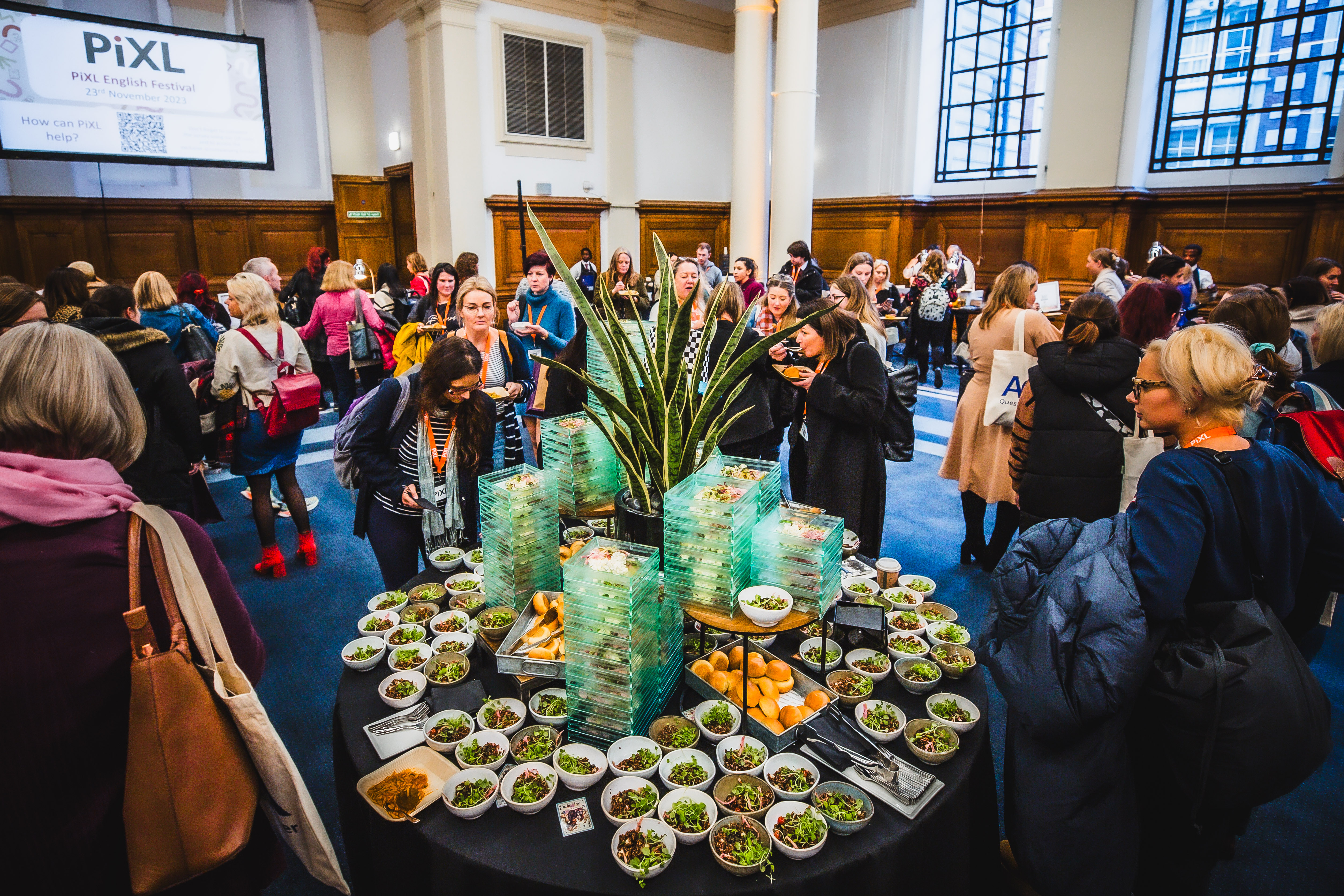 Networking event in Central Hall Westminster with vibrant food display and engaged attendees.