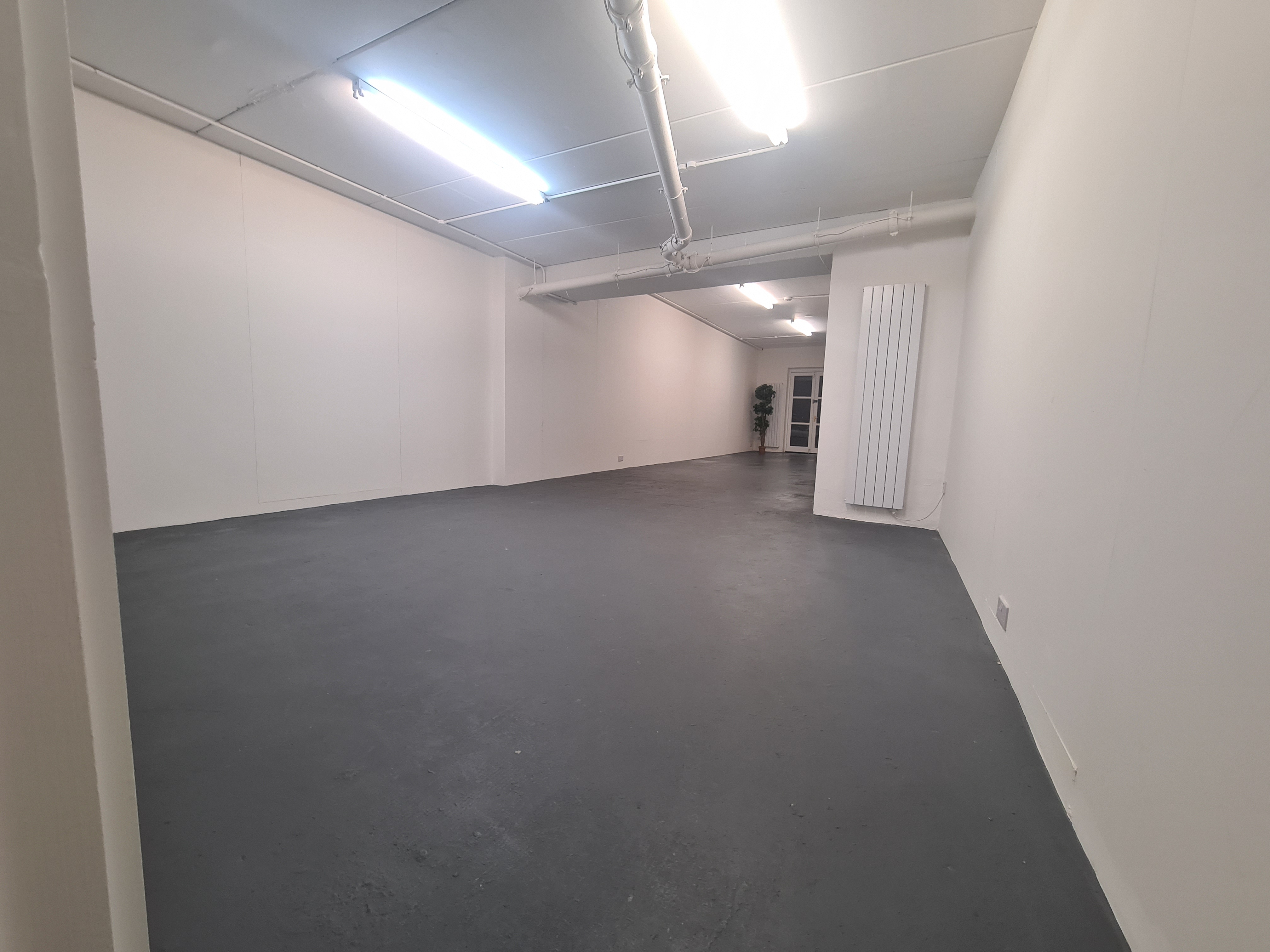 Versatile event space in B. T. Batsford Gallery with polished floor, ideal for workshops and networking.