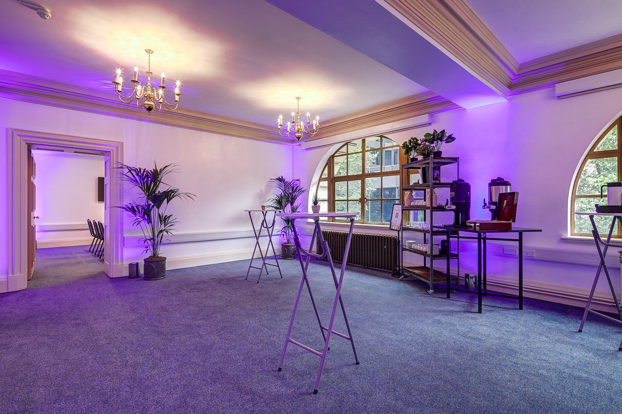 John Tudor in Central Hall Westminster with elegant chandeliers for events and meetings.