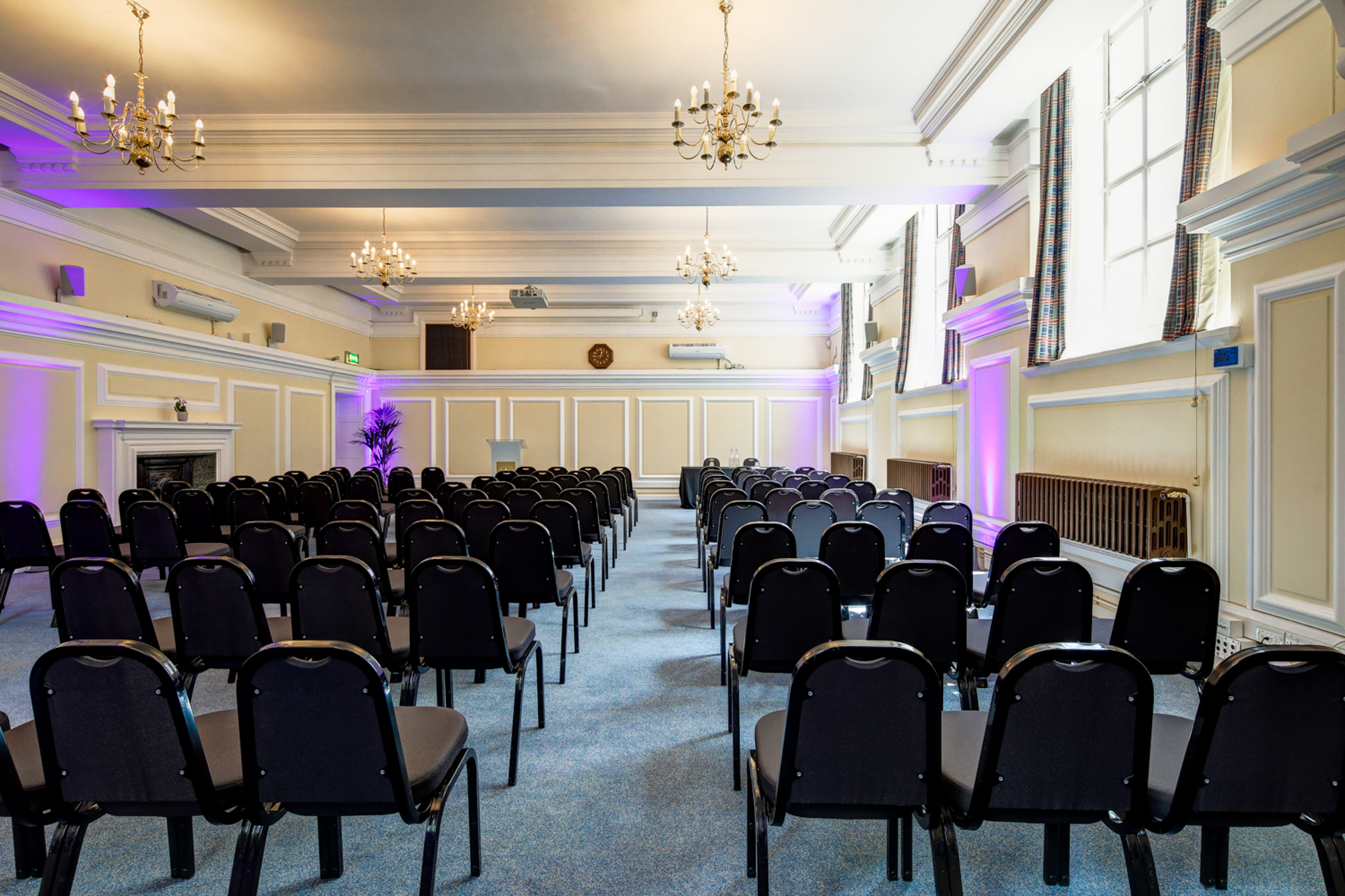 Robert Perks in Central Hall Westminster, elegant meeting space with purple lighting.