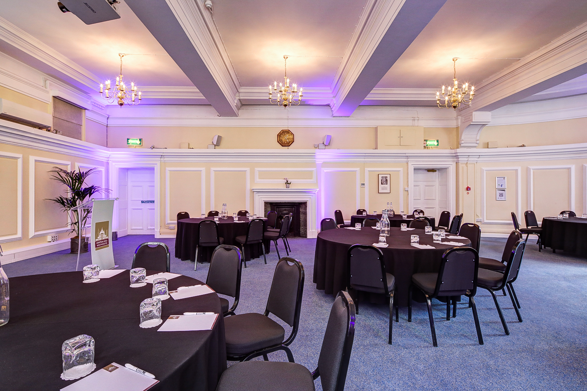 George Thomas in elegant Central Hall Westminster event space with round tables for networking.