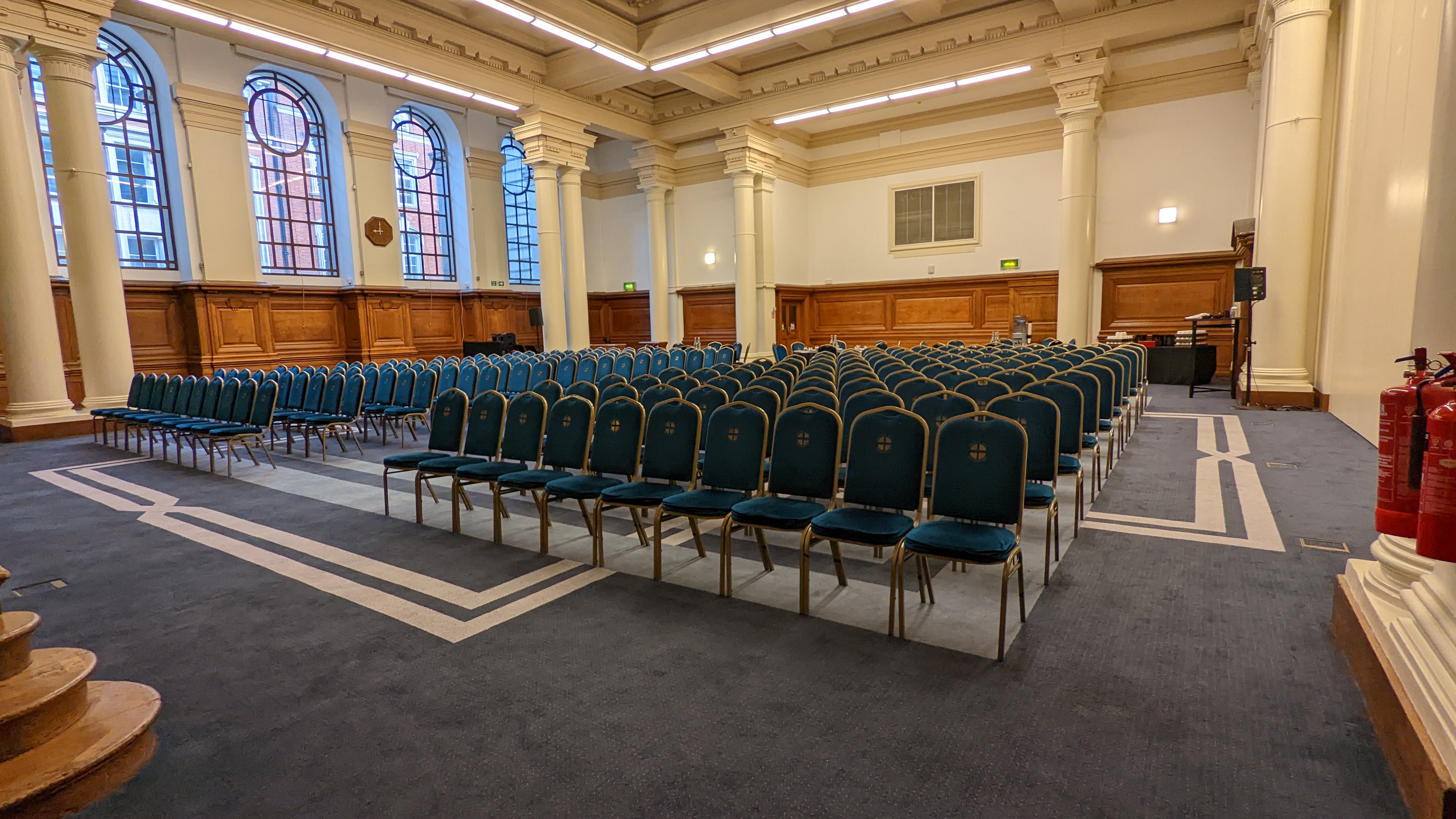 Lecture Hall in Central Hall Westminster with blue chairs, ideal for meetings and presentations.