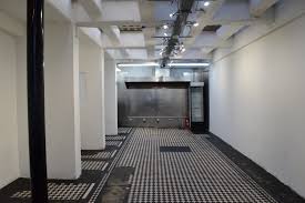 Spacious minimalist venue with white walls for corporate events and workshops.