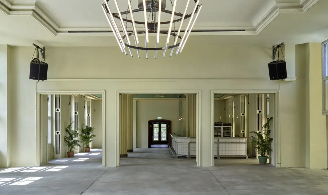 Spacious wedding venue with modern design, ideal for receptions and conferences.