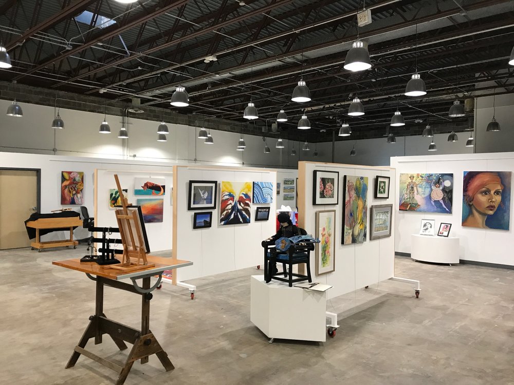 Versatile event space with movable walls for art exhibitions and networking events.