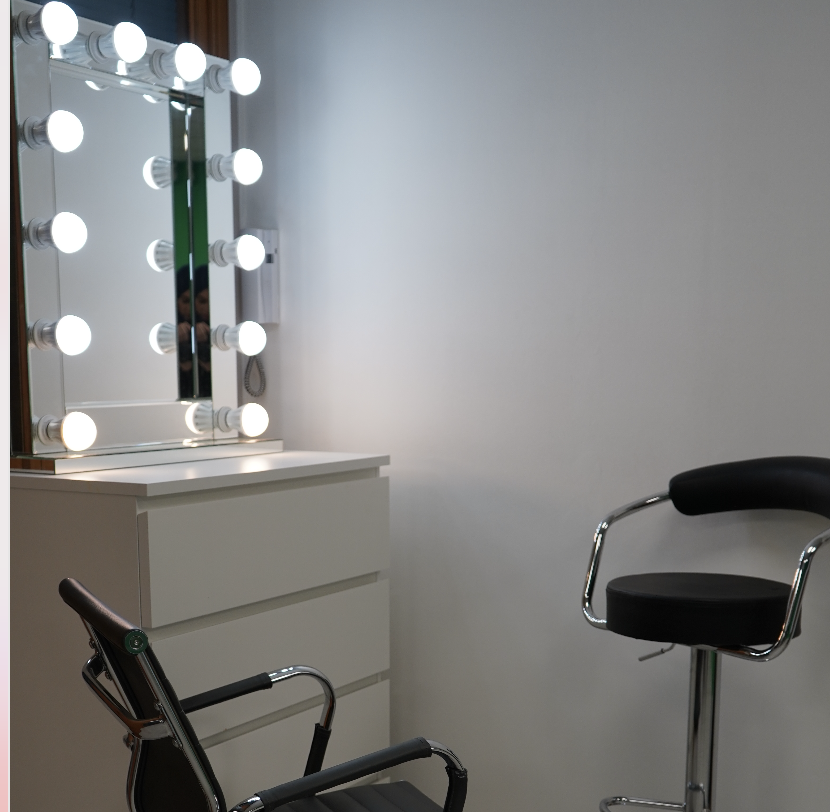 Makeup station with bright vanity mirror for pre-event preparations at A&B Films Studio.