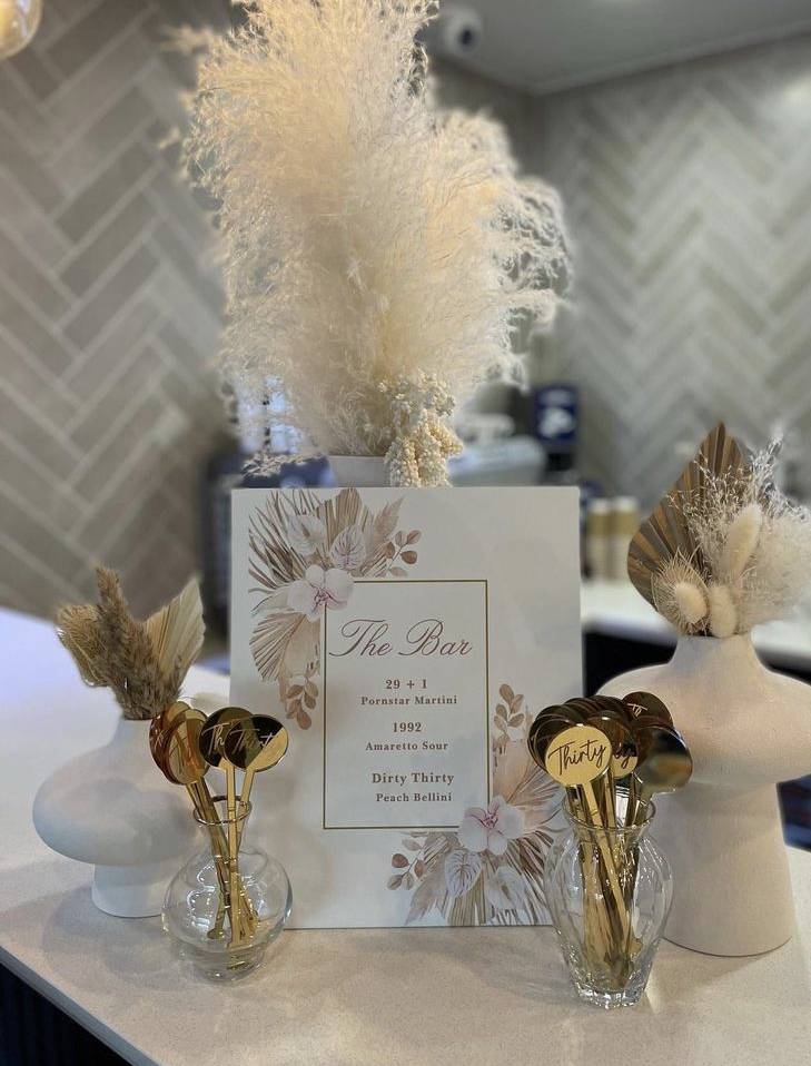 Chic sports bar setup with elegant floral decor for events at PSA Performance Centre.