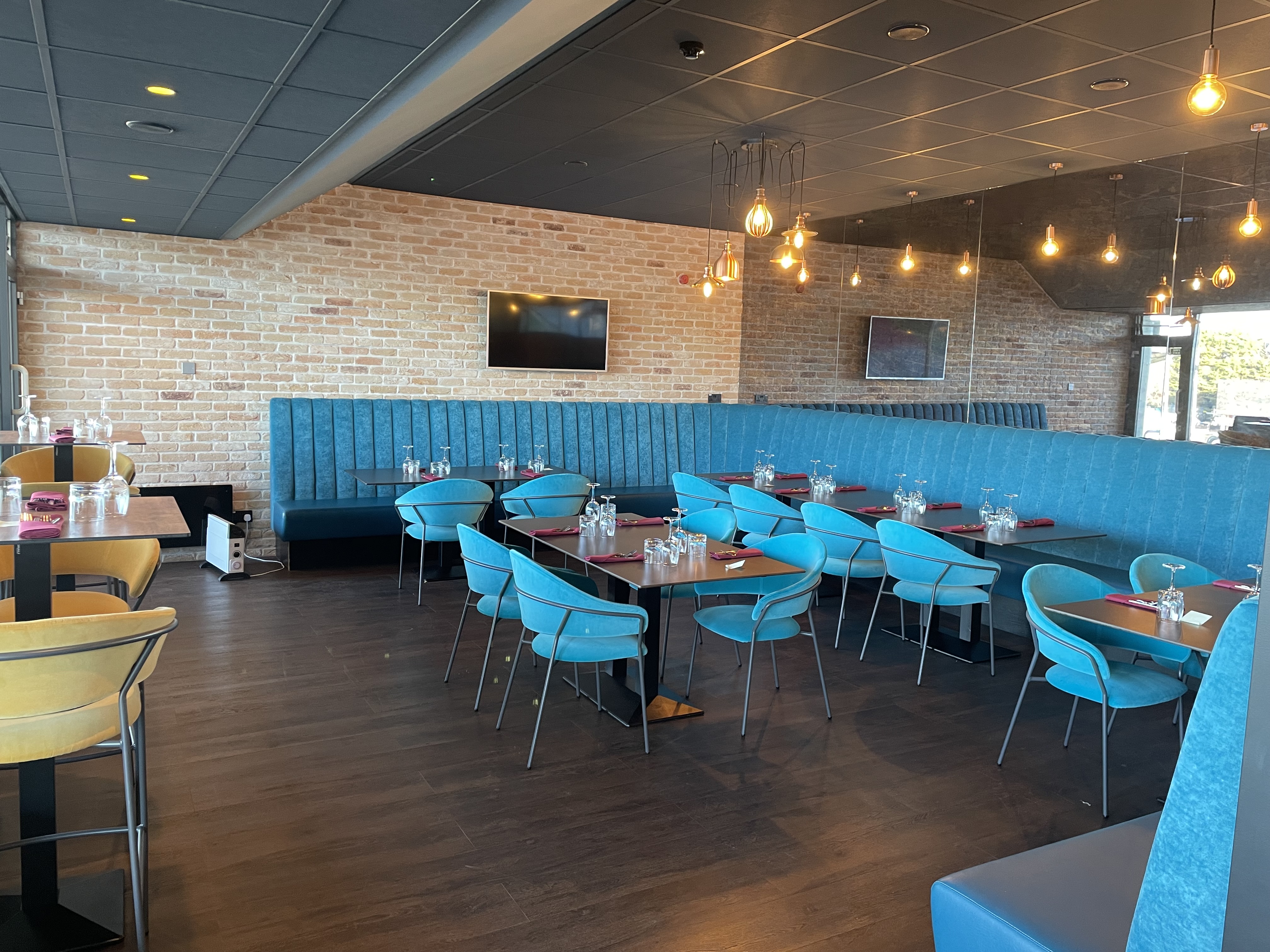 Modern dining space at The Clubhouse, Twickenham Stoop Stadium for events and gatherings.