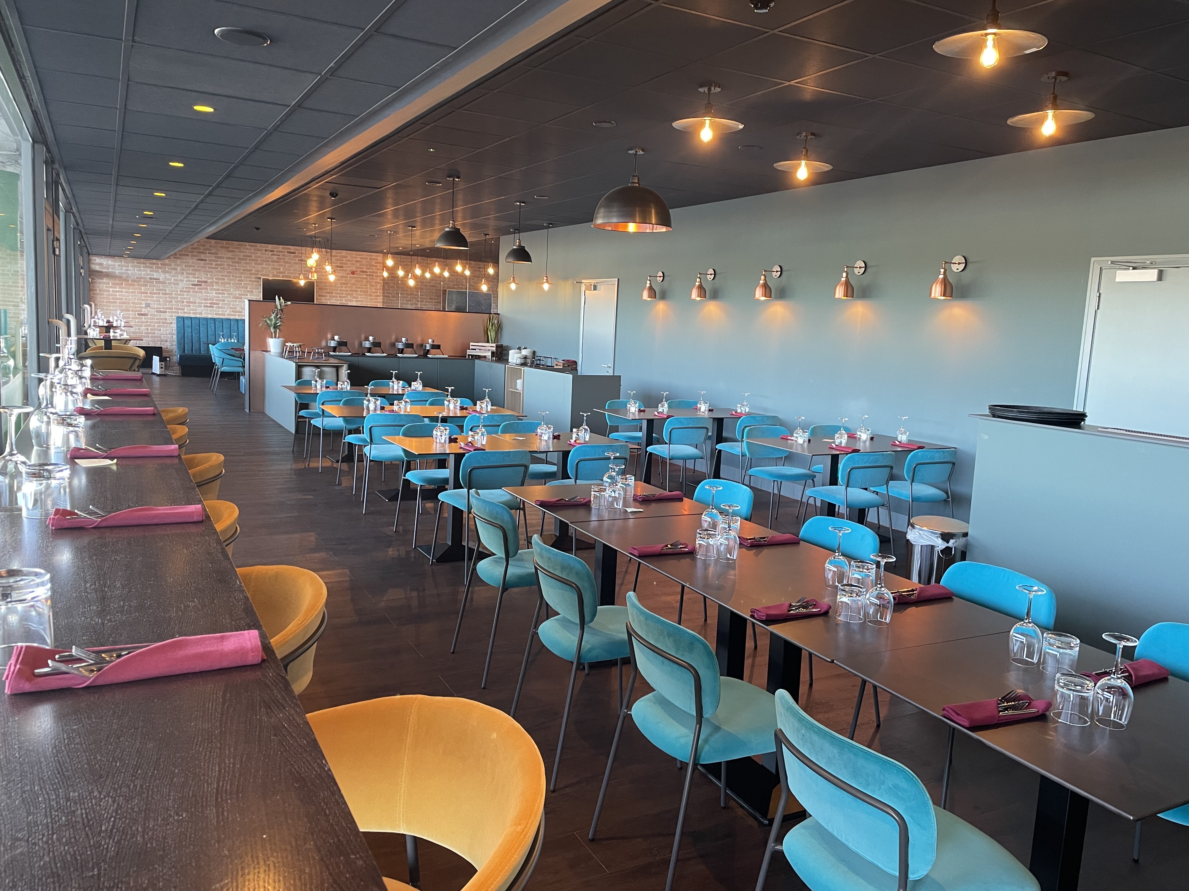 Modern dining space at The Clubhouse, Twickenham Stoop Stadium for events and gatherings.