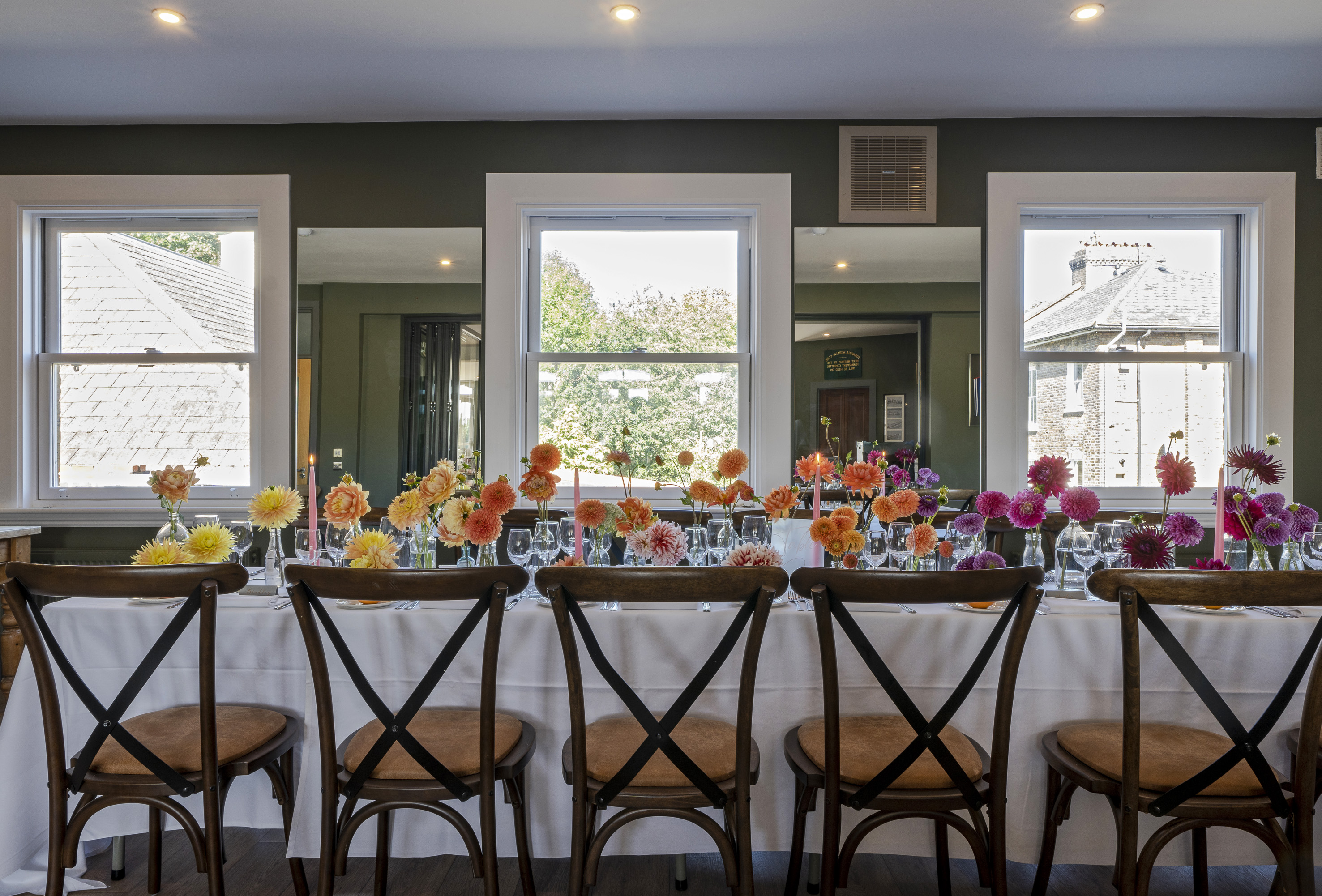 Furnivall Club Room dining setup with floral centerpieces for intimate events and gatherings.