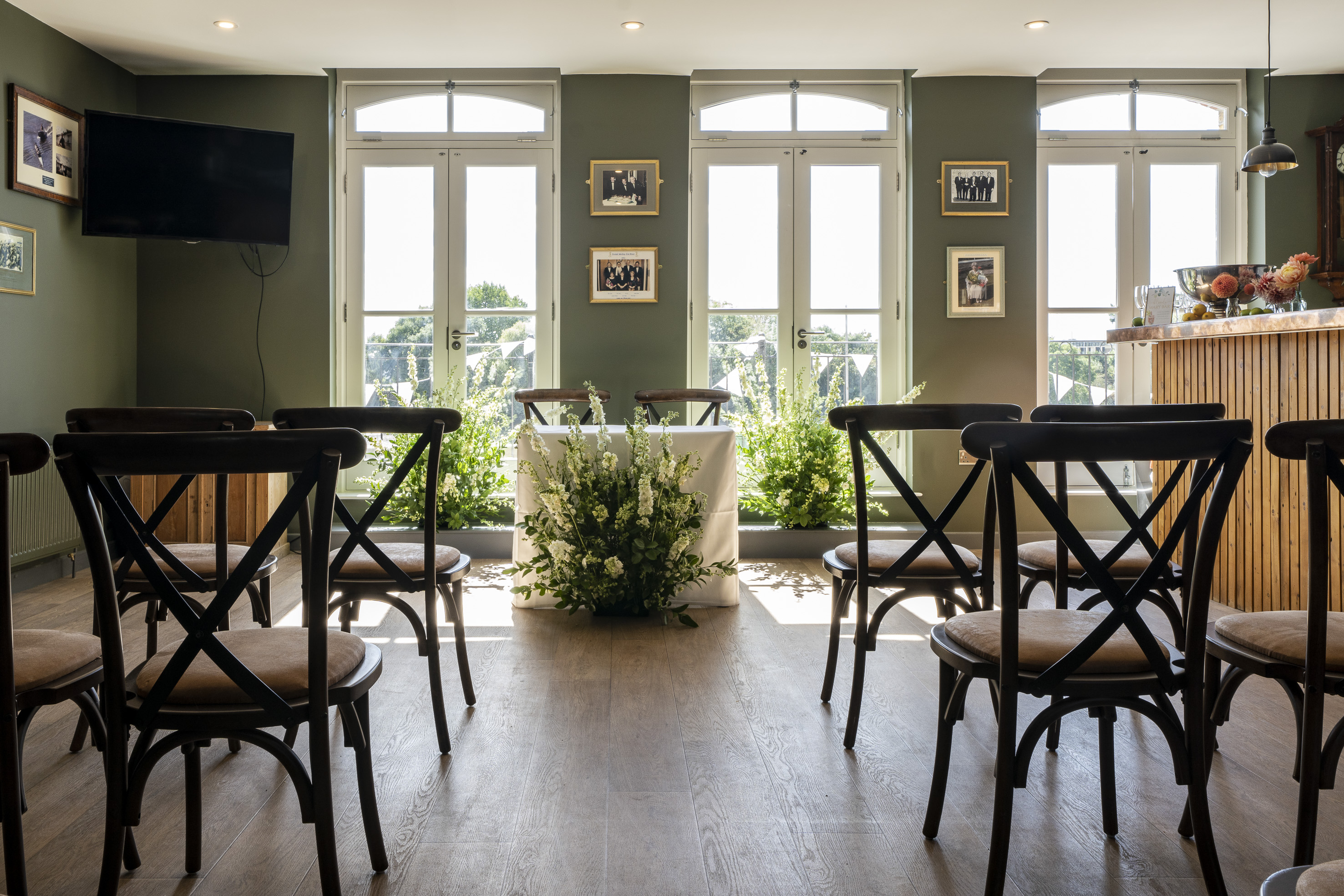 Furnivall Club Room: elegant meeting space with floral decor, ideal for gatherings and receptions.