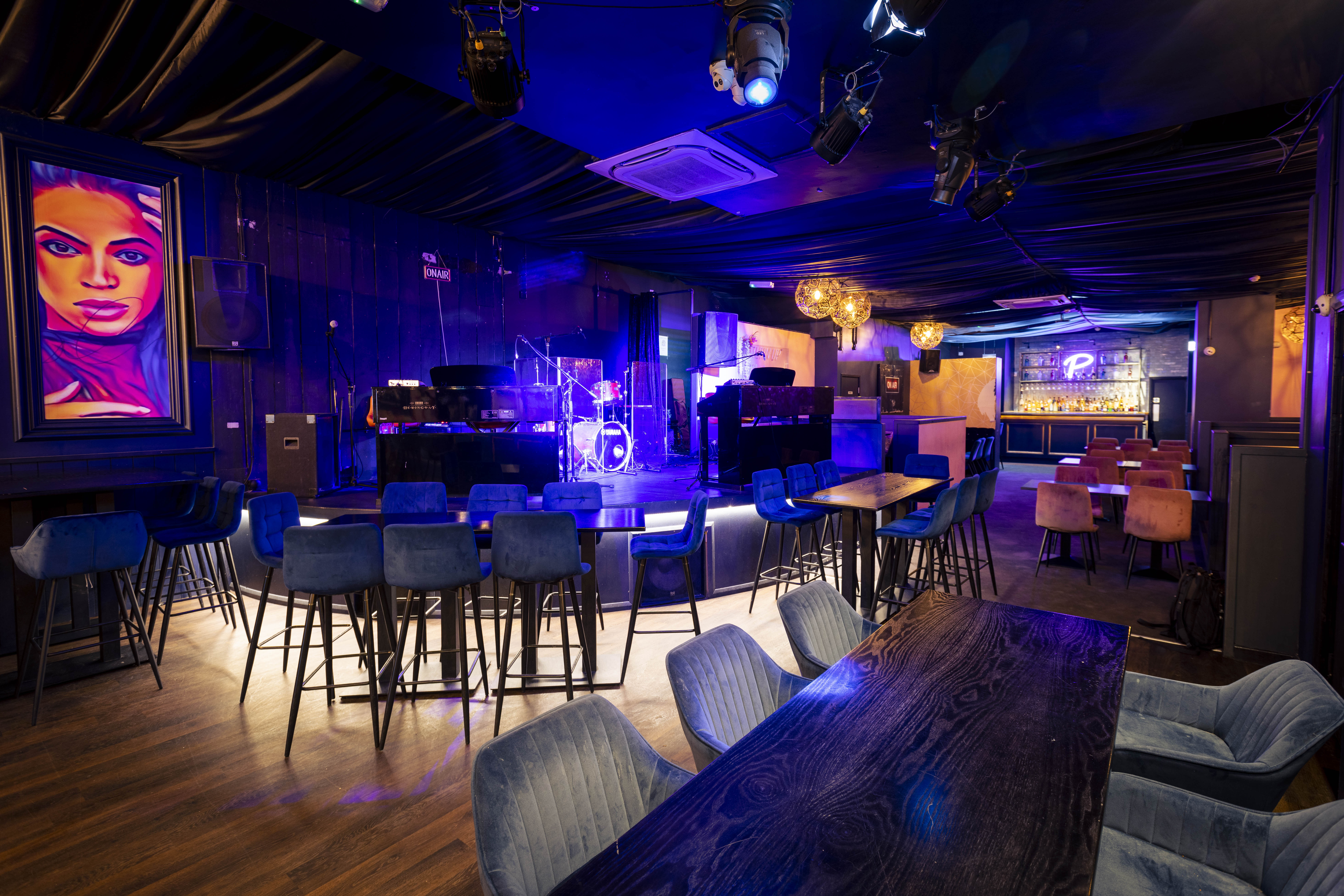 Vibrant event space with stylish decor for live performances and social gatherings.
