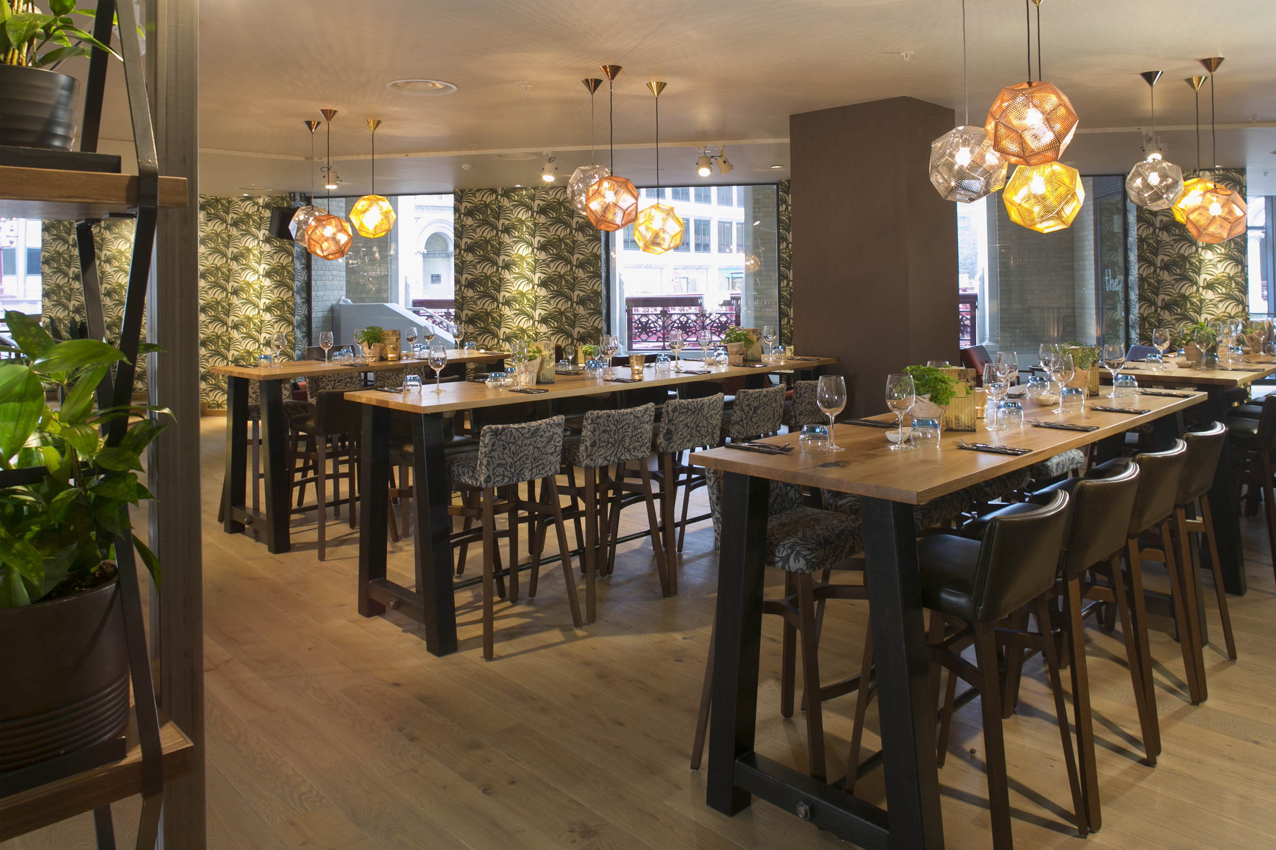 Modern event space with communal tables, ideal for networking and gatherings.