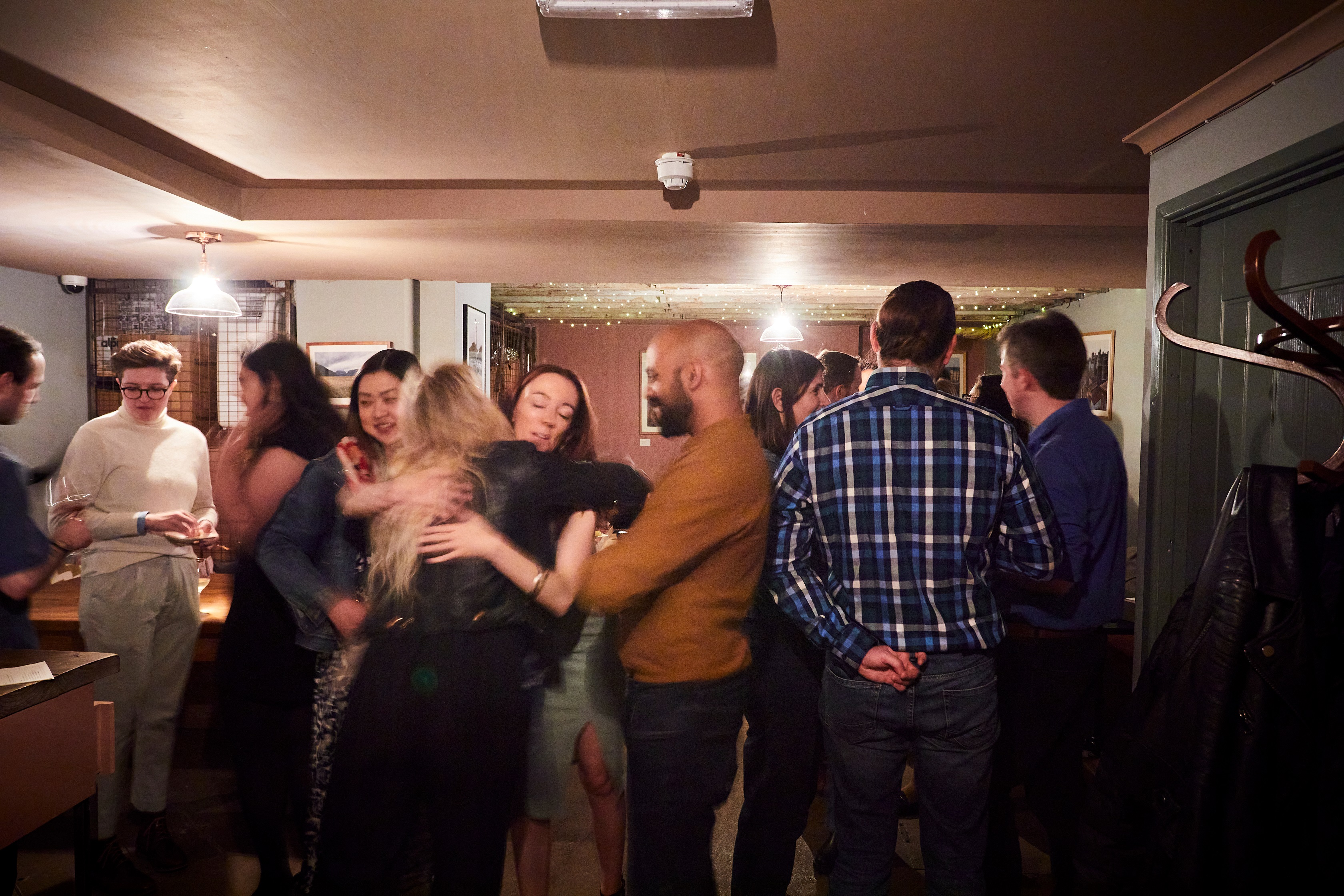 Lively networking event at The Cellar, featuring casual attire and engaged interactions.