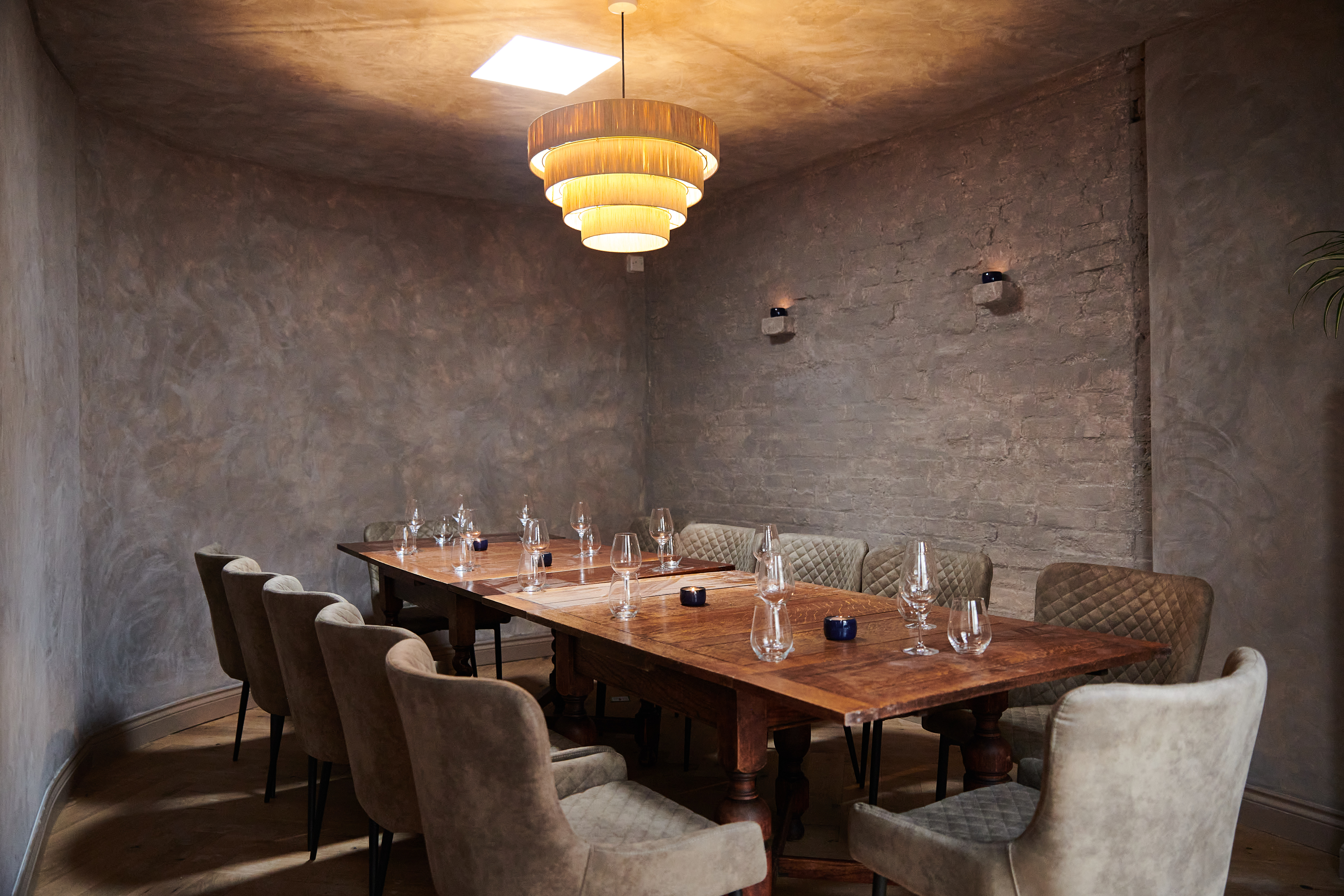 Intimate meeting room with rustic wooden table, ideal for small gatherings and brainstorming.
