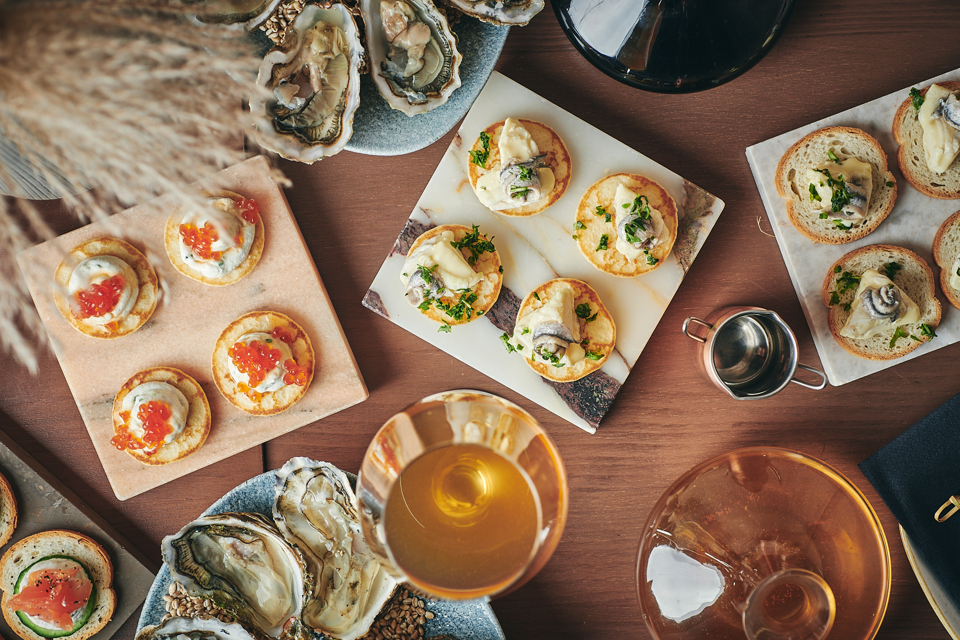 Elegant gourmet hors d'oeuvres and oysters for a high-end networking event.