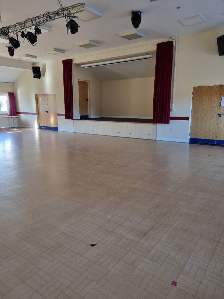 Windsor Hall in Skipsea Village: spacious event venue with raised stage for gatherings.