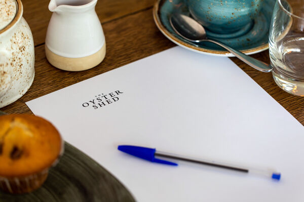 Meeting setup at The Cabin in The Oyster Shed with branded stationery and refreshments.
