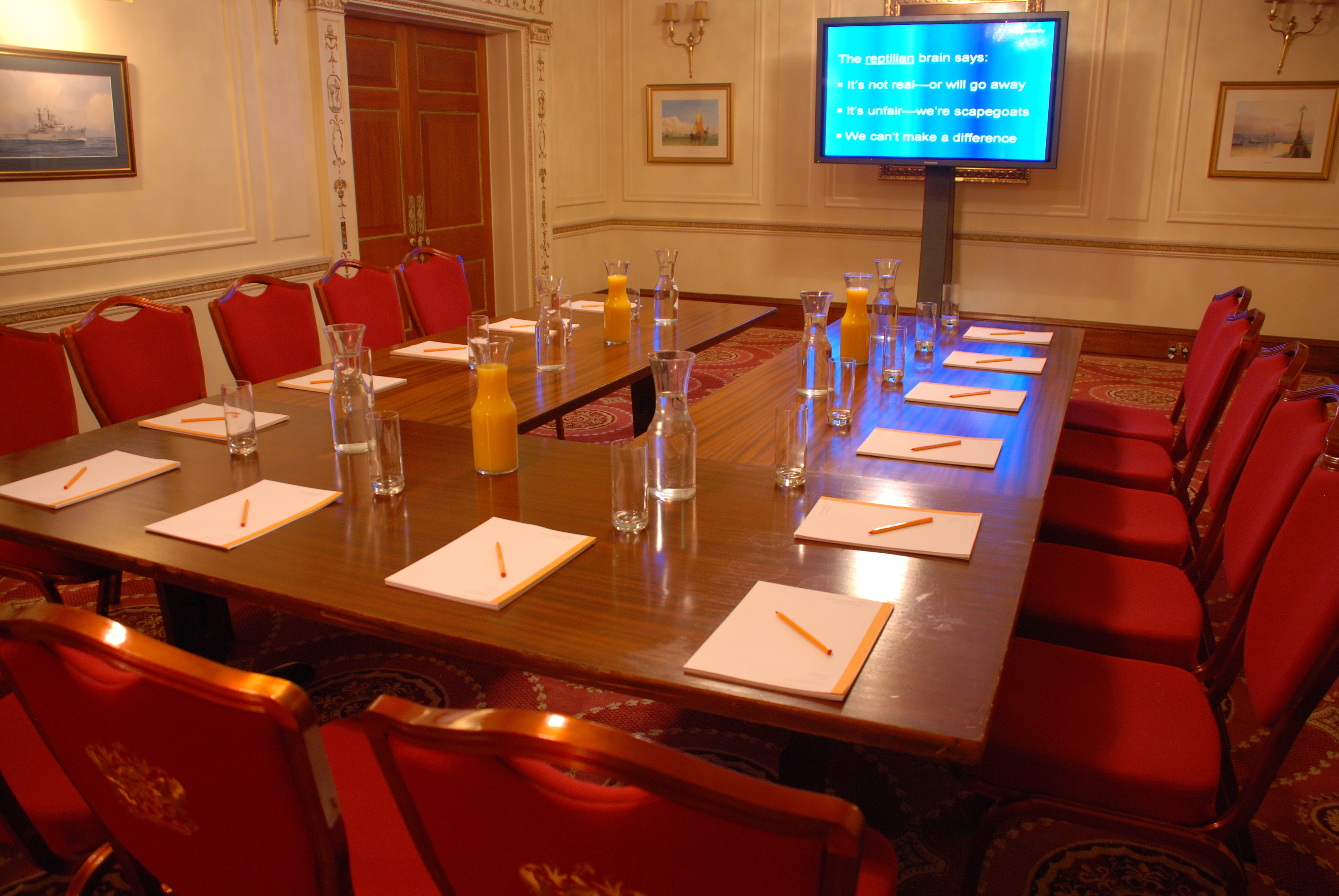 Humber Room at Plaisterers’ Hall, elegant meeting space with large table and red chairs.