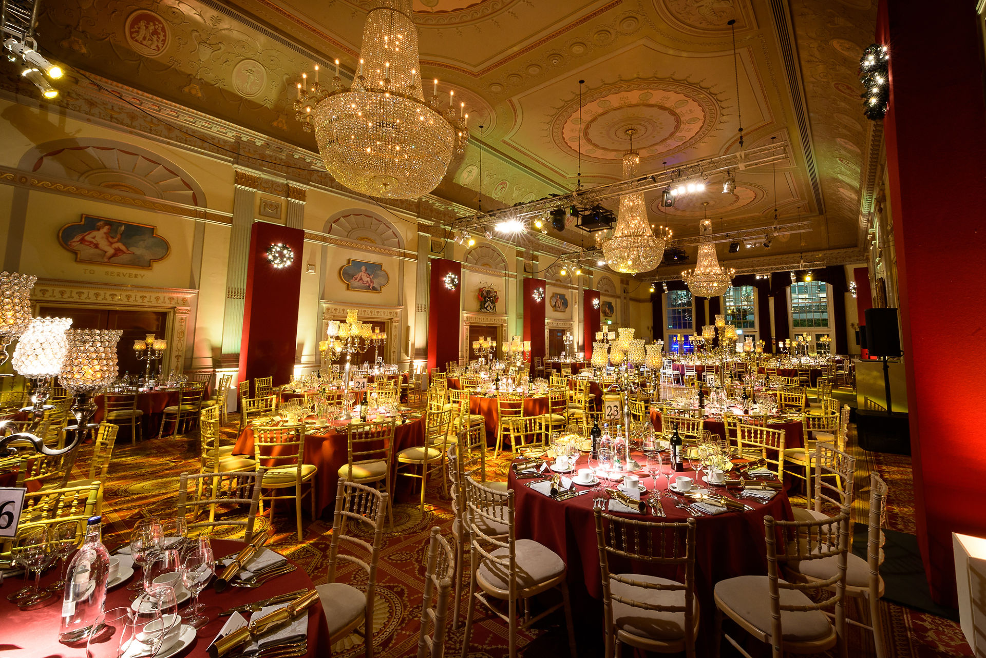 Elegant banquet hall with chandeliers for upscale Christmas parties and corporate events.