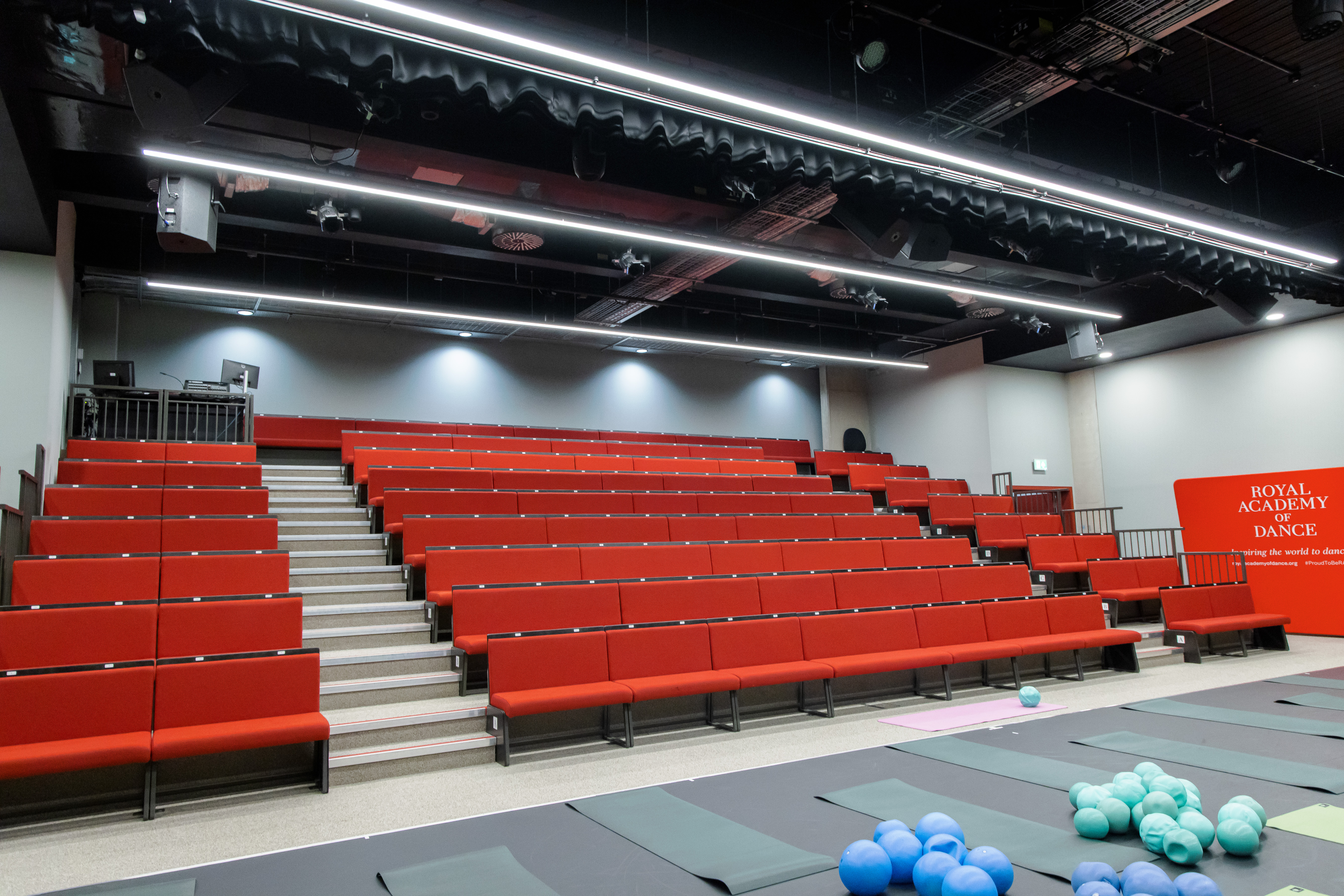 Aud Jebsen Studio Theatre with tiered red seating for performances and workshops.