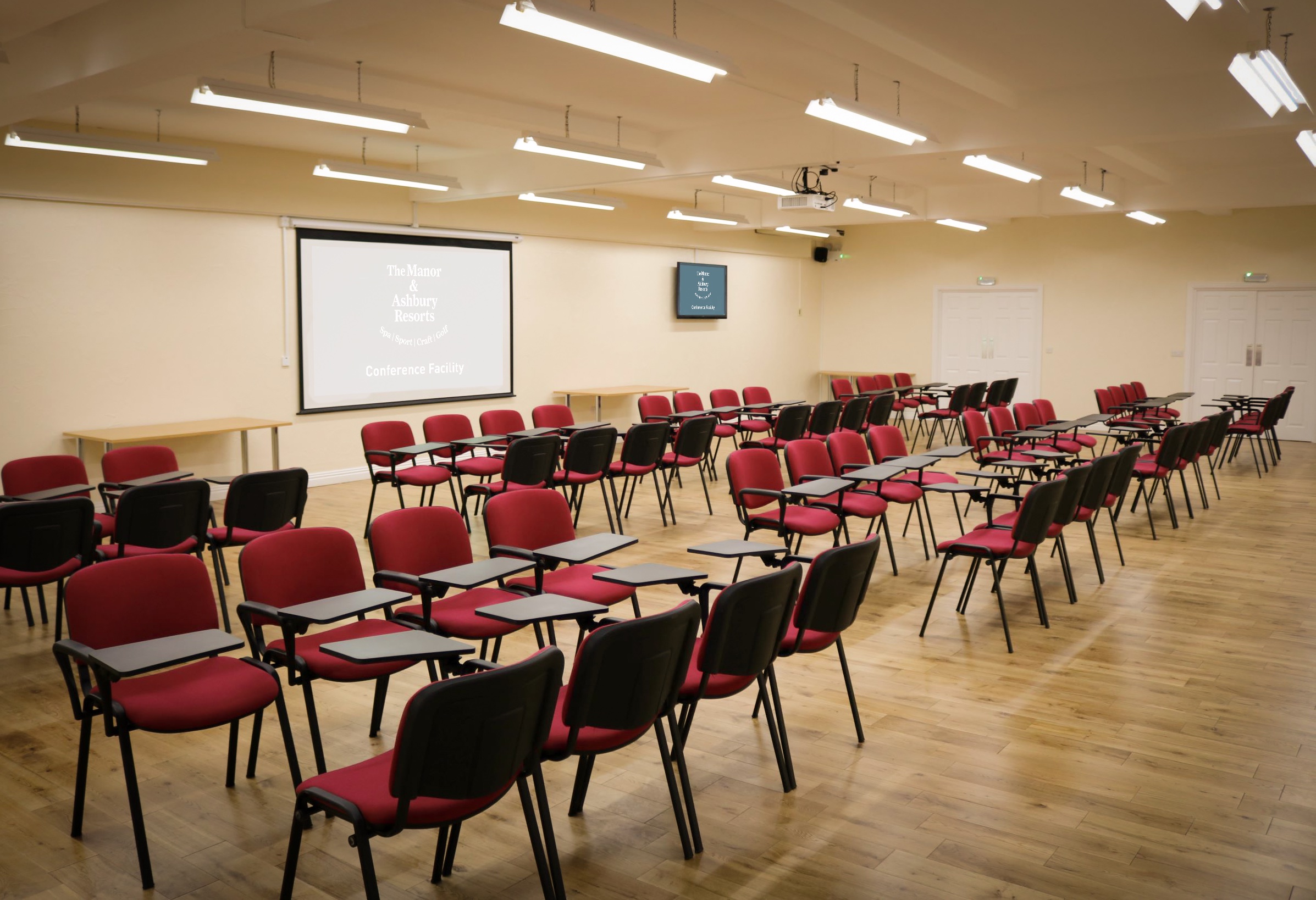Meeting room setup with red chairs for workshops at Manor & Ashbury Resorts.